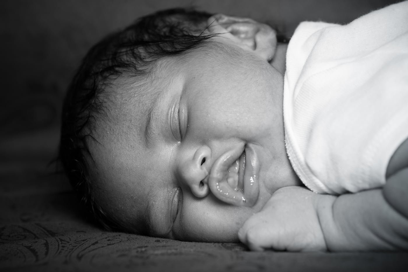 Newborn smiling, B&W.