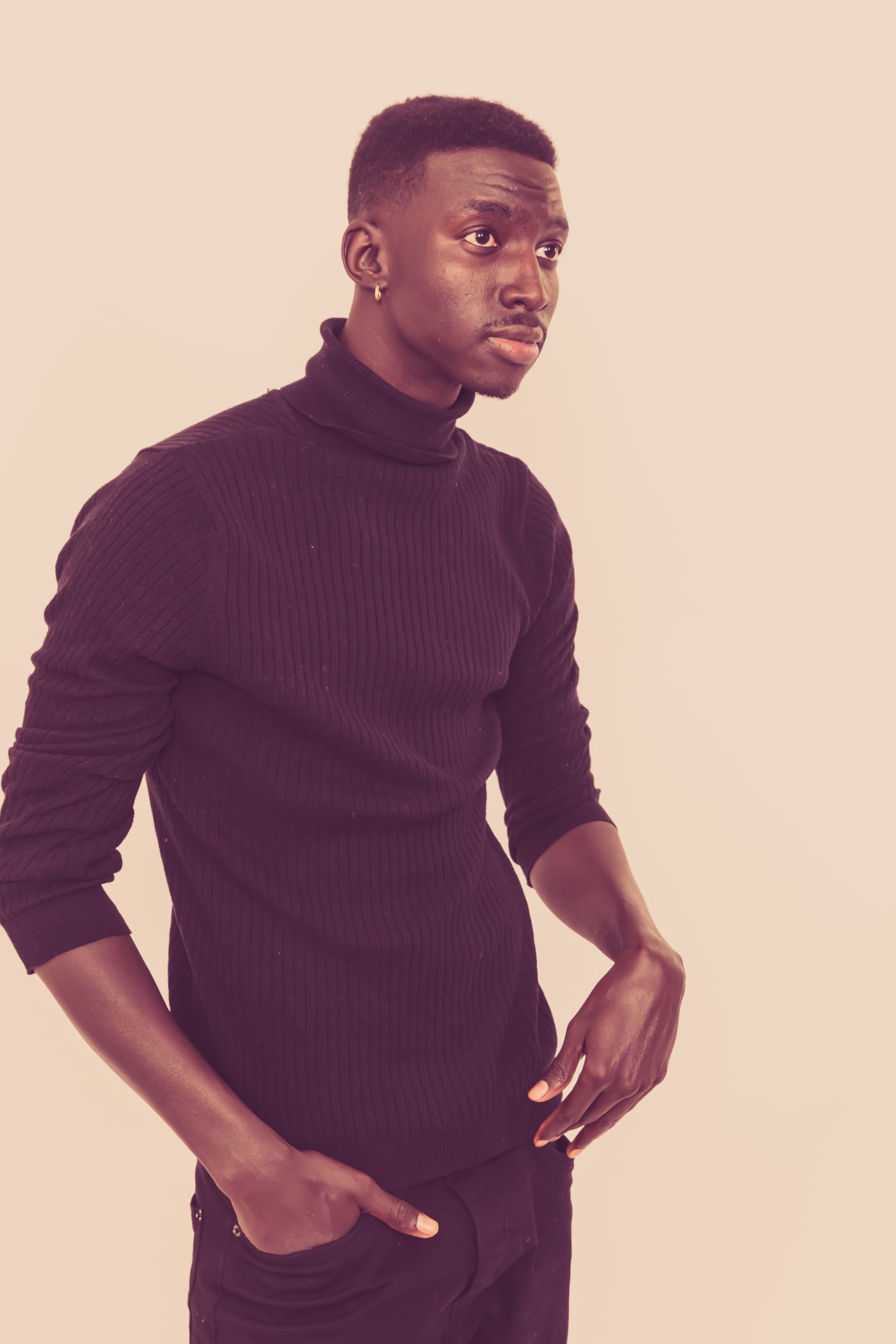 Black male model purple turtleneck, full-length fashion.