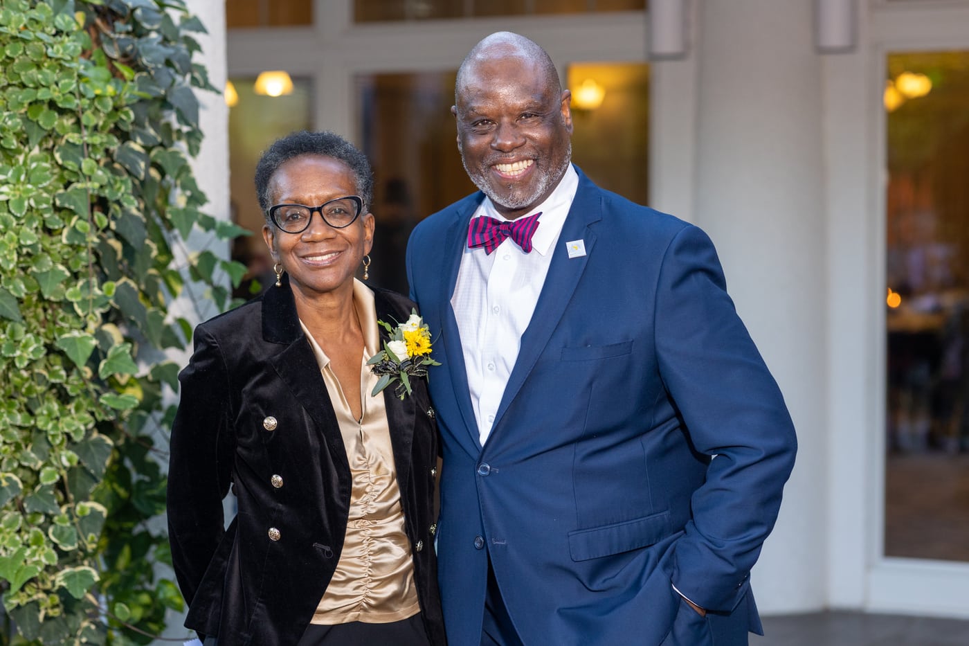 Couple at gala, bowtie, warm.