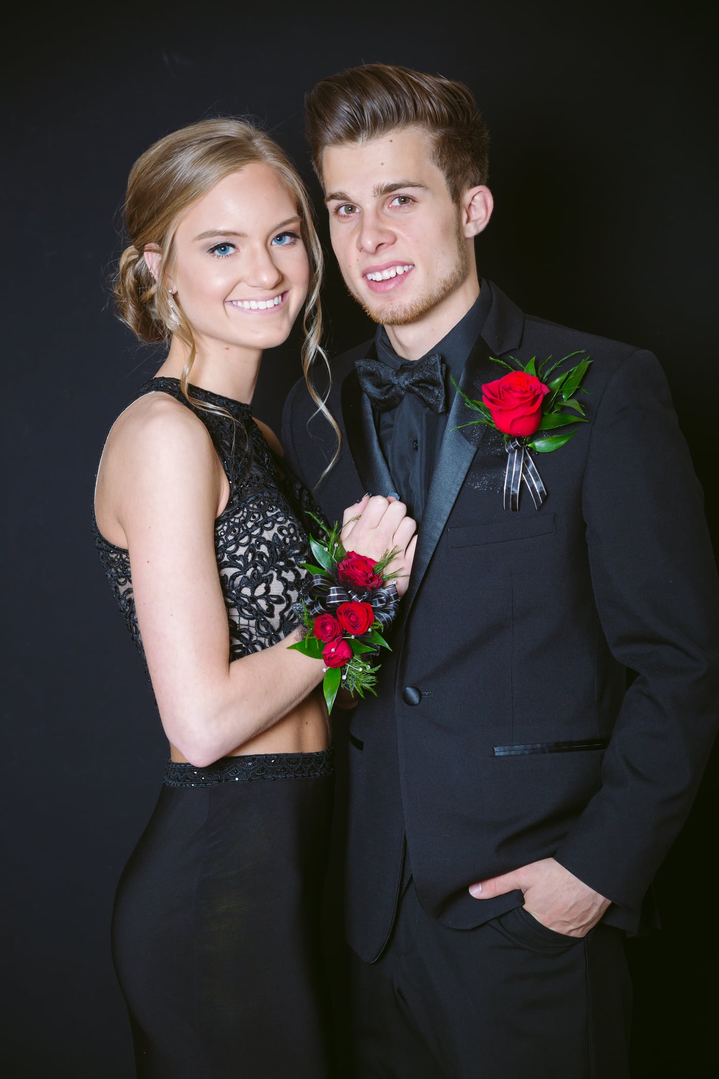Prom couple, red rose corsage, formal.