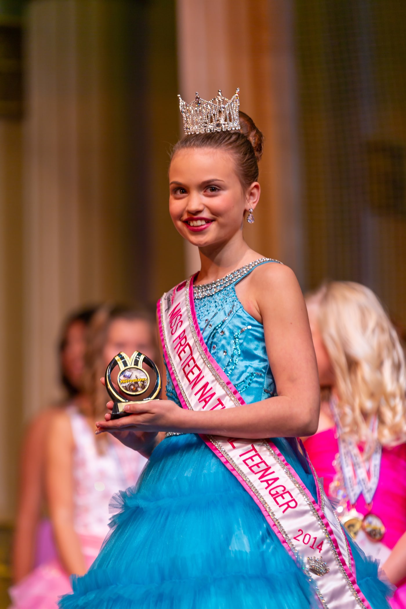 Award moment with crown and trophy.
