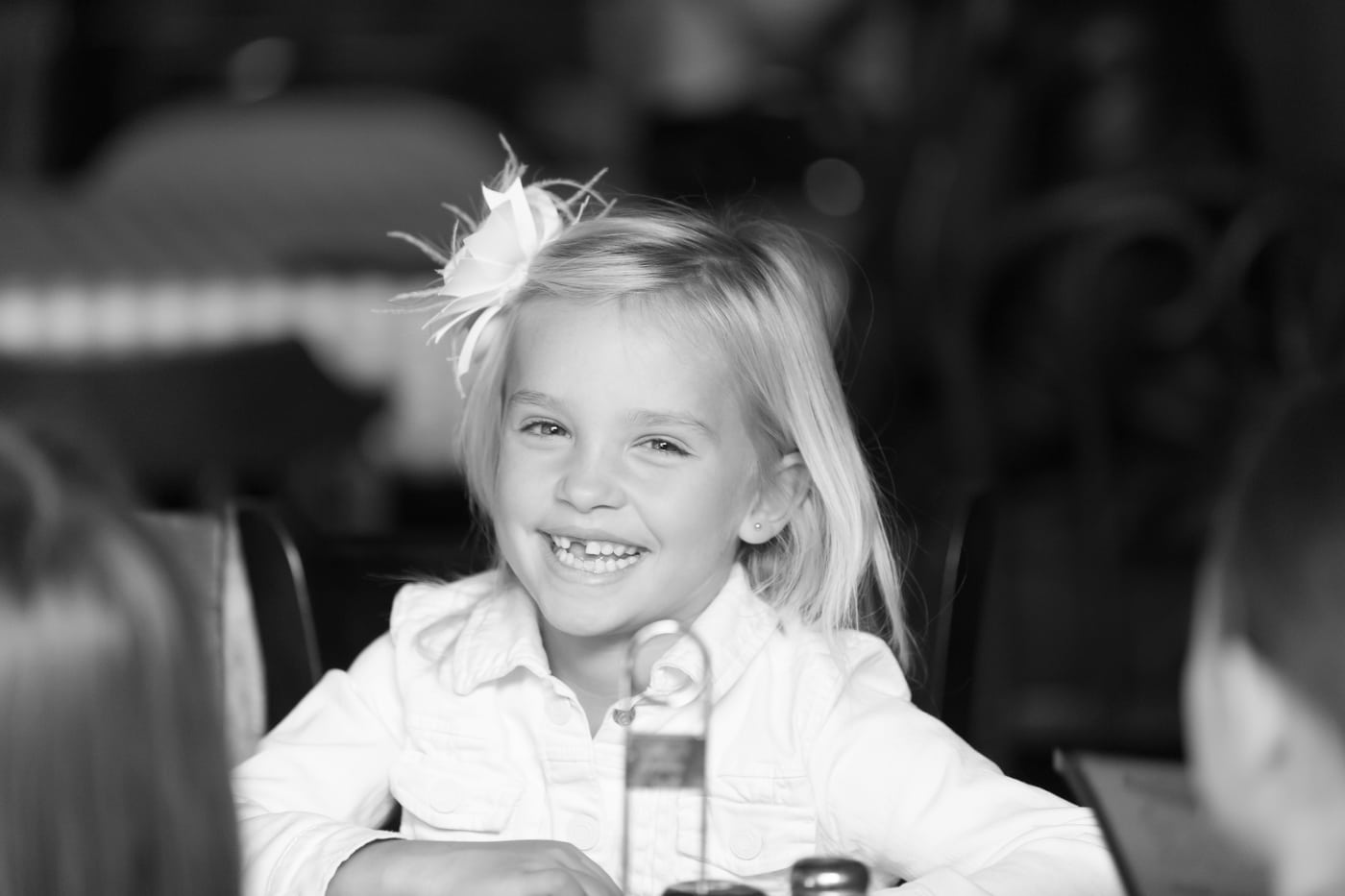 Little girl with feather, B&W laughing, children.