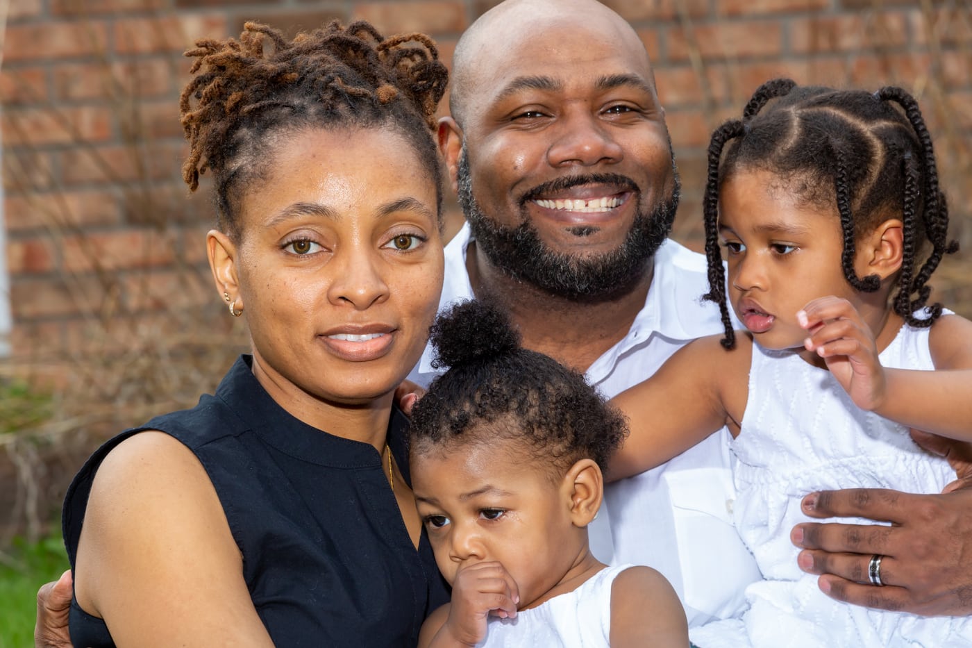 Family of five outdoors, joyful.