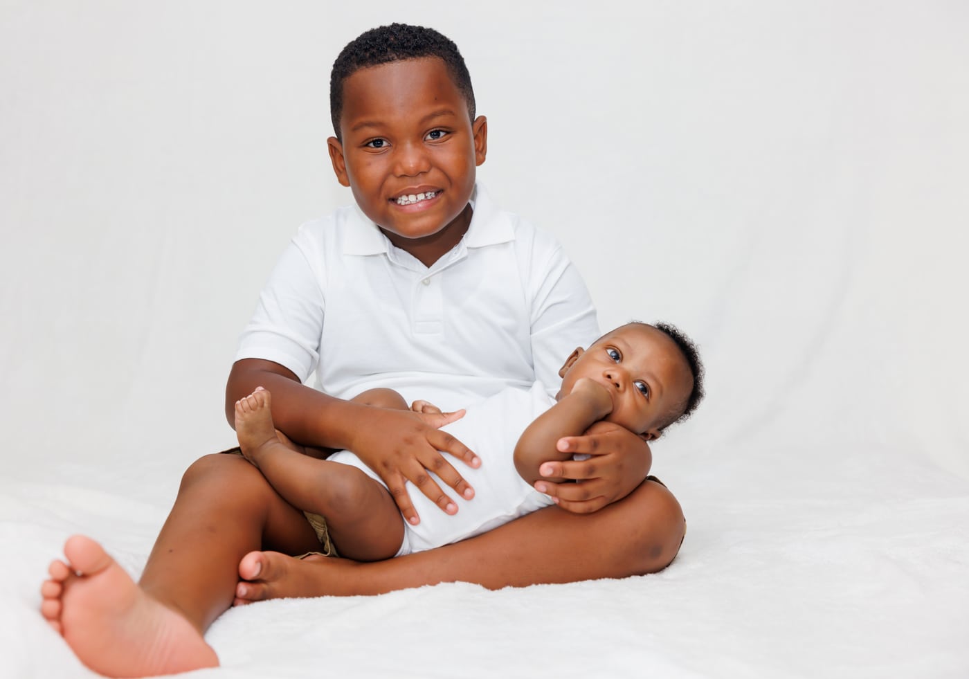 Two boys + baby, white polos, siblings.