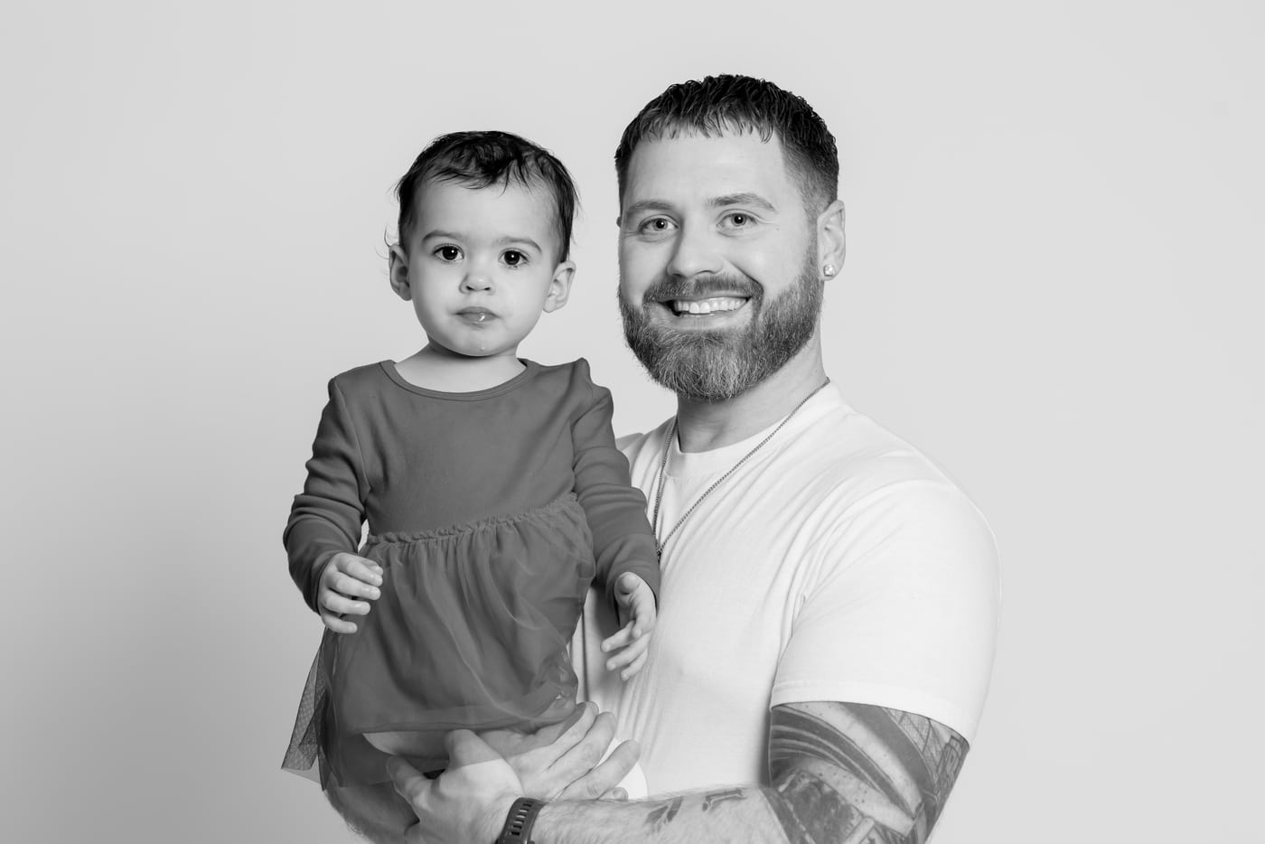 Dad + toddler, B&W studio, tender.