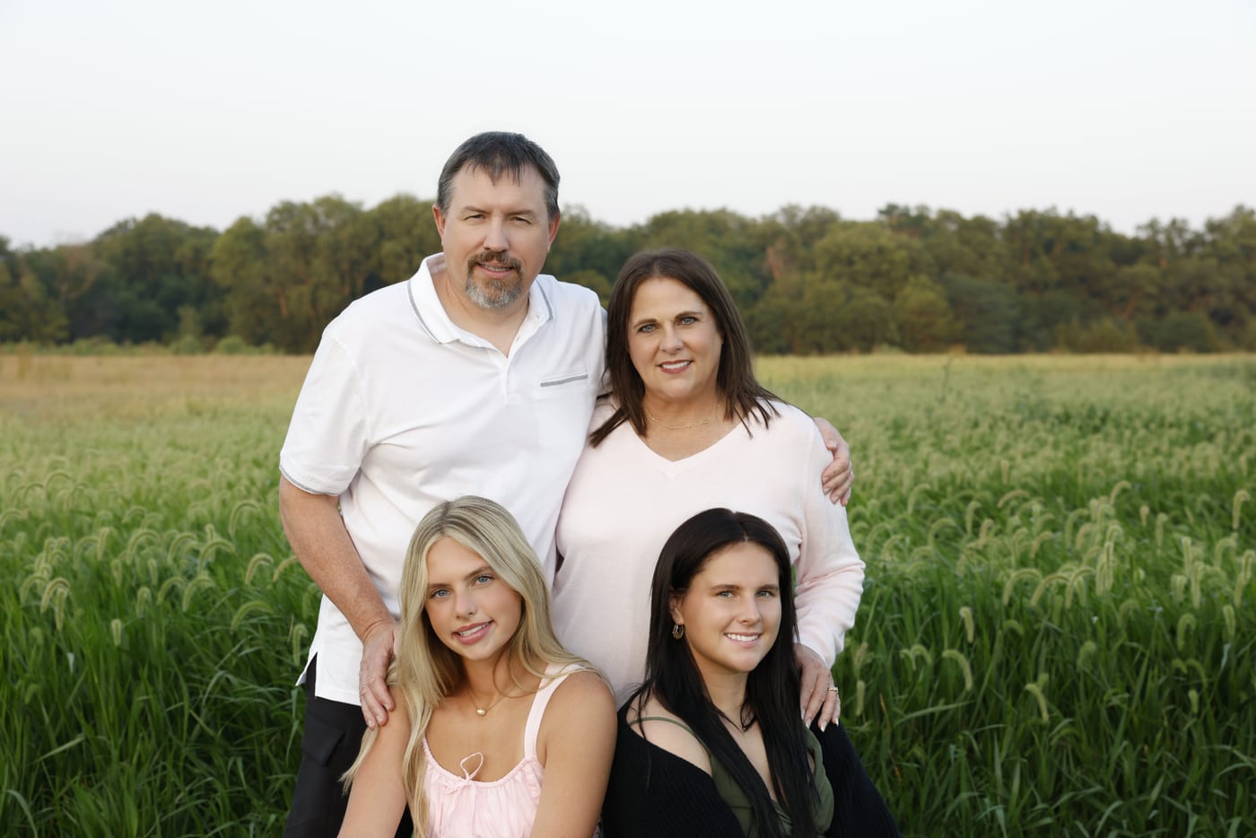 Family in field, warm.
