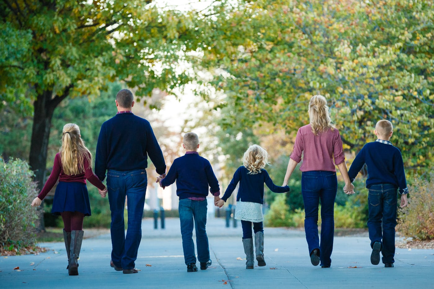 Family walking away, autumn path, storytelling.