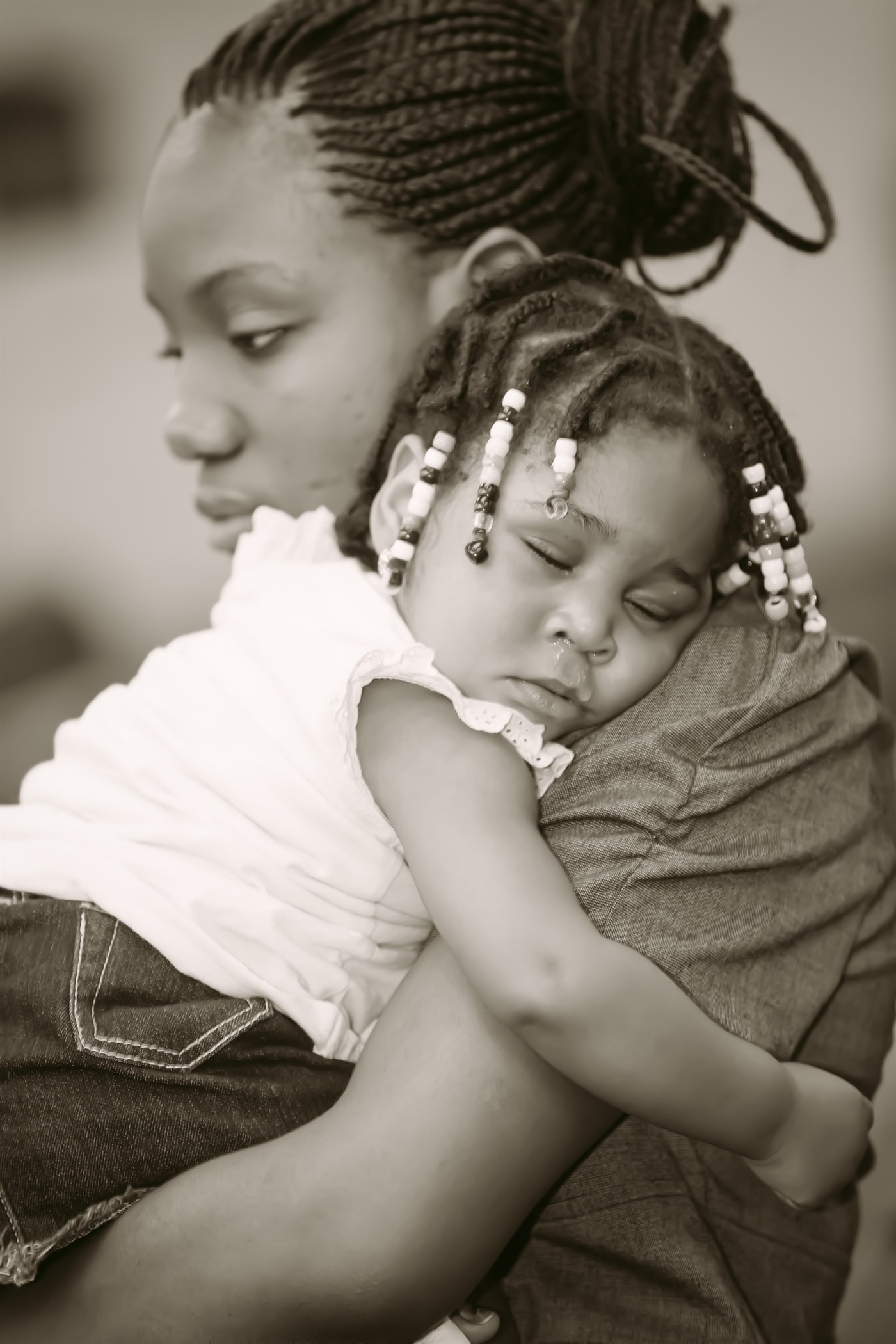 Mother and baby black-and-white portrait. Photograph by Samuel Mfinanga for Mfinanga Photography + Motion.