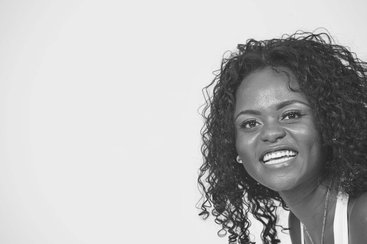 Woman B&W, big smile, headshot.