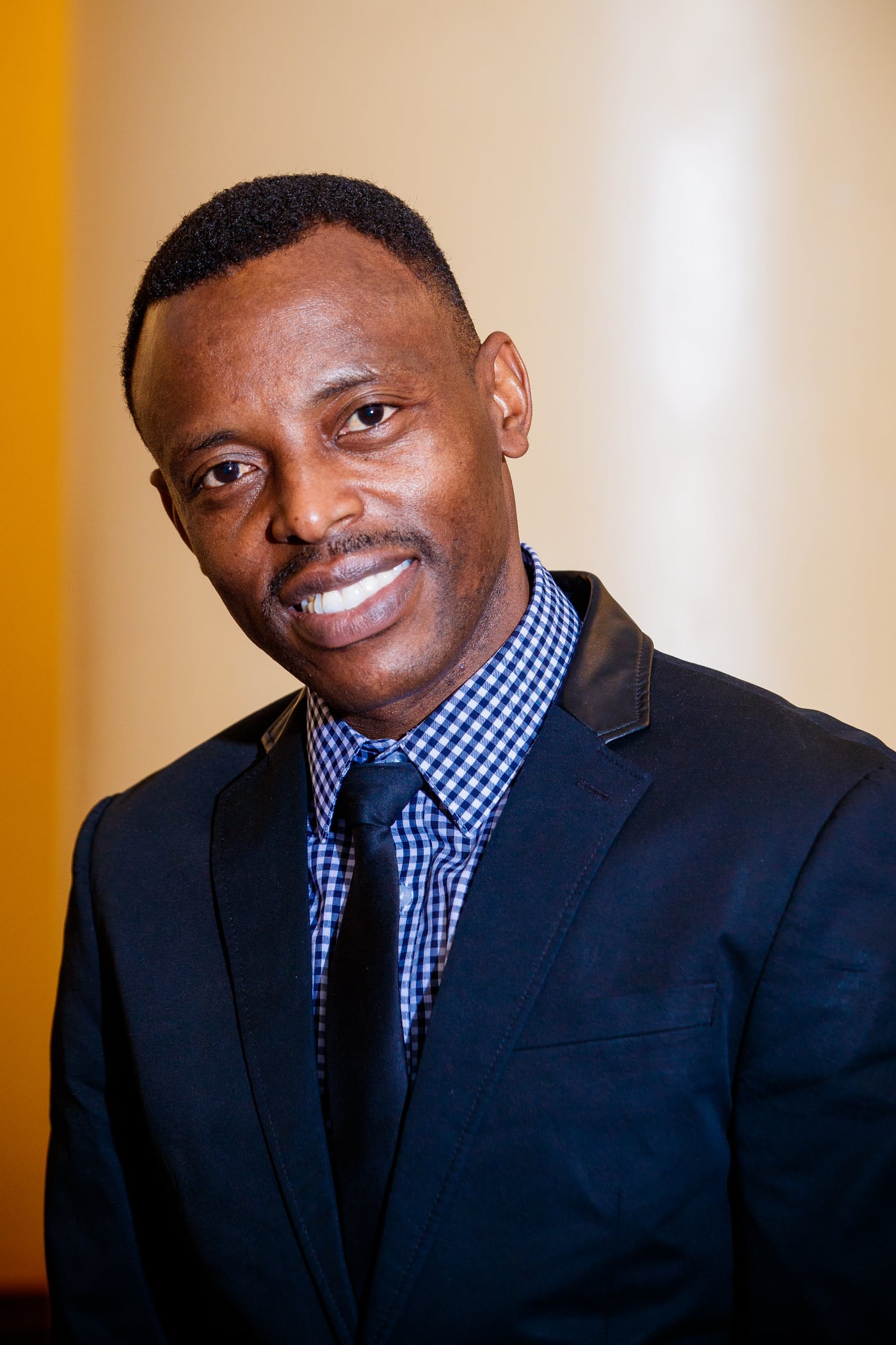 Executive man blue checked blazer, headshot.