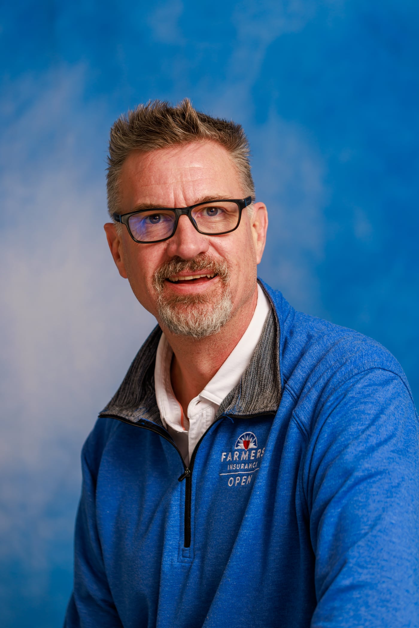 Executive man blue quarter-zip.