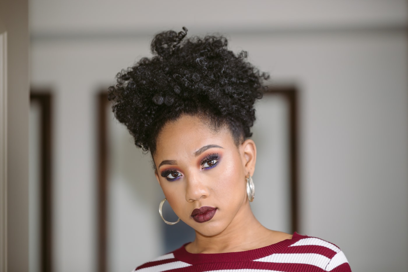 Polished studio headshot, direct gaze. Photograph by Samuel Mfinanga for Mfinanga Photography + Motion.