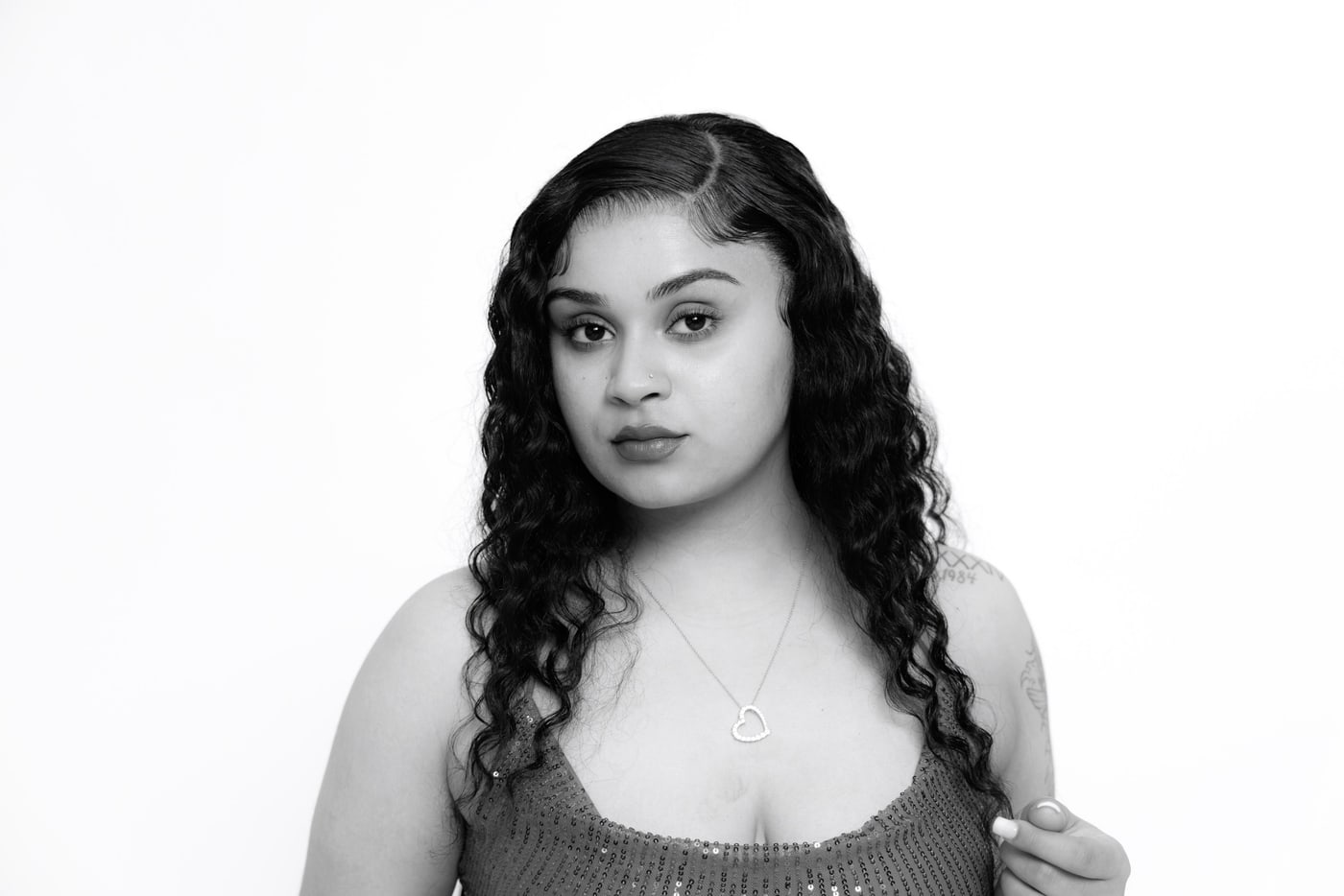 Black-and-white studio portrait with clean professional styling.