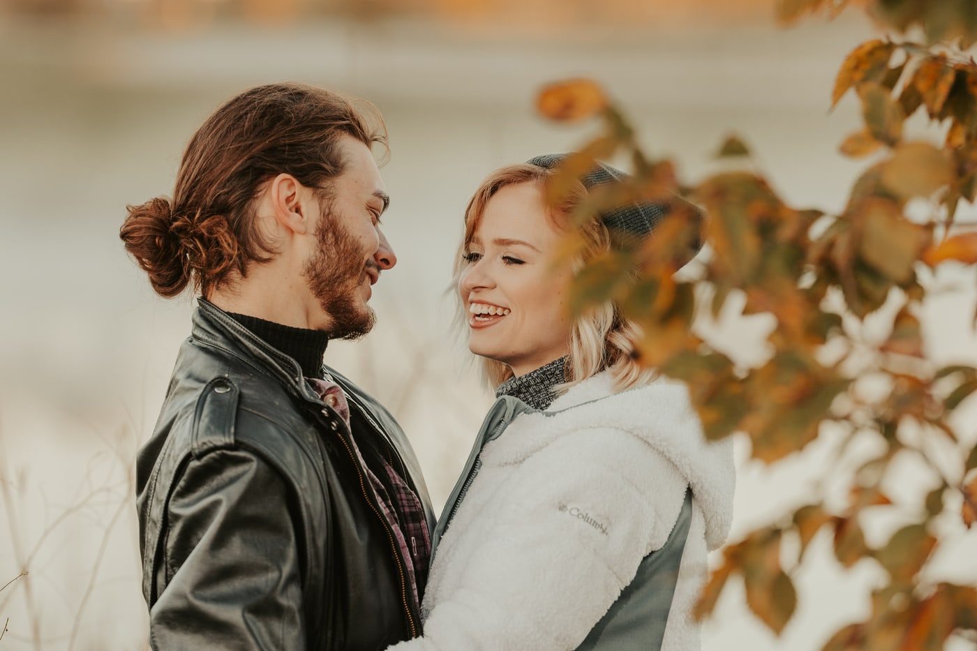 Couple face-to-face laughing, autumn golden, engagement hero. Photograph by Samuel Mfinanga for Mfinanga Photography + Motion.