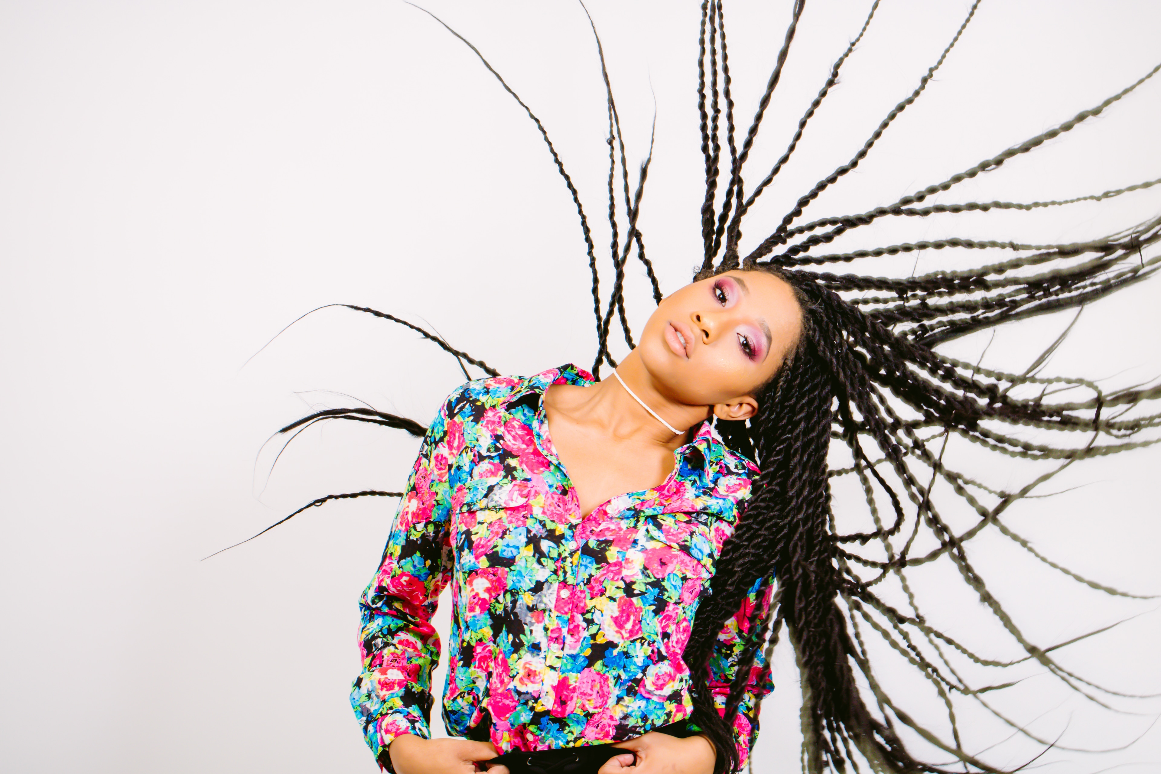 Bright hair-motion editorial portrait.