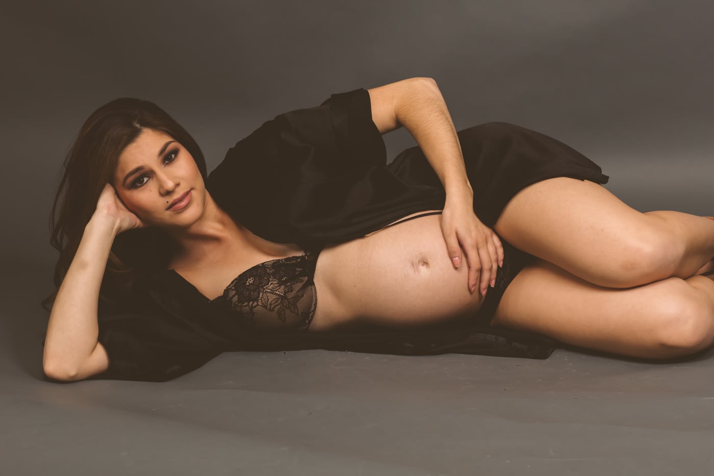 Reclining black lace, belly, dramatic (APPROVAL: boudoir register).