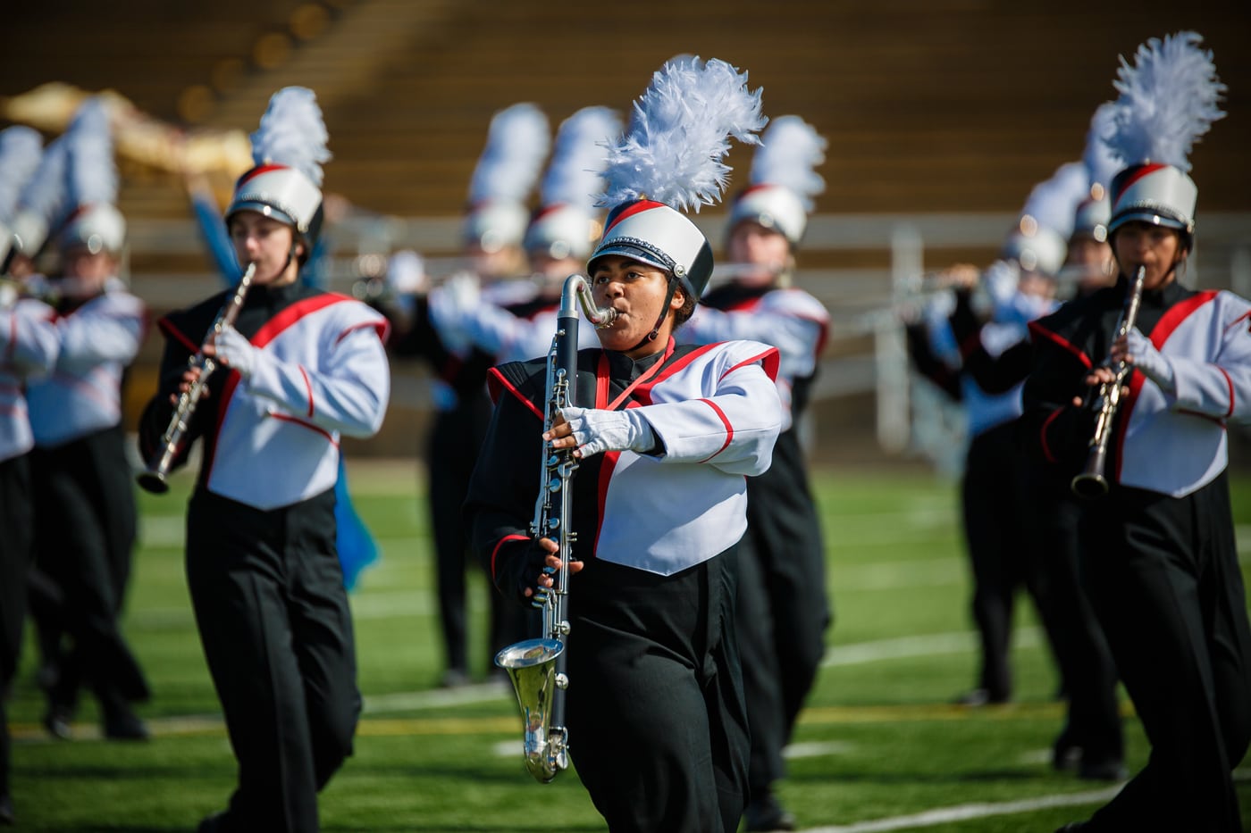 Marching band clarinets on field.