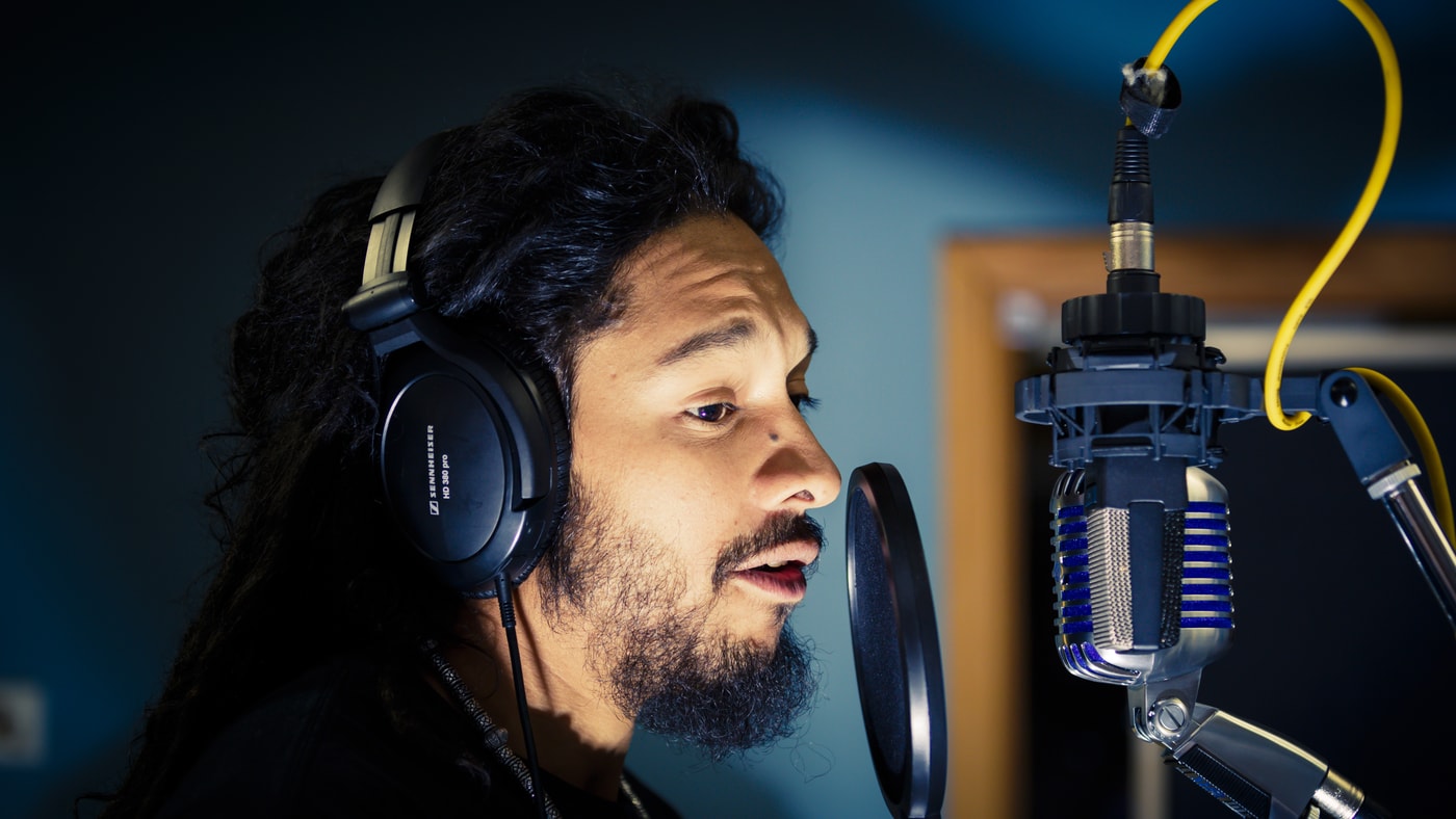 Recording studio vocalist with broadcast microphone.