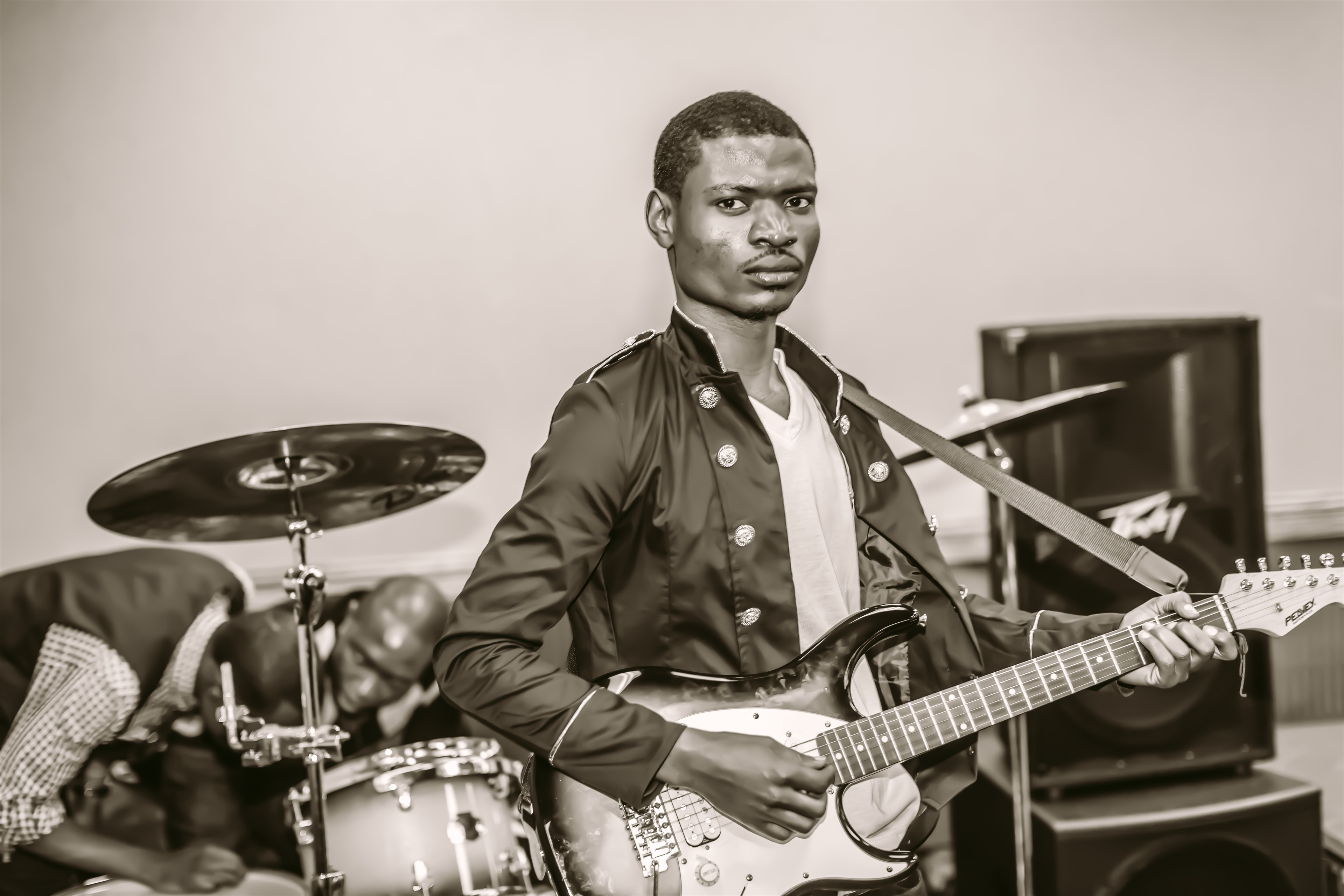 Black-and-white guitarist performance portrait.