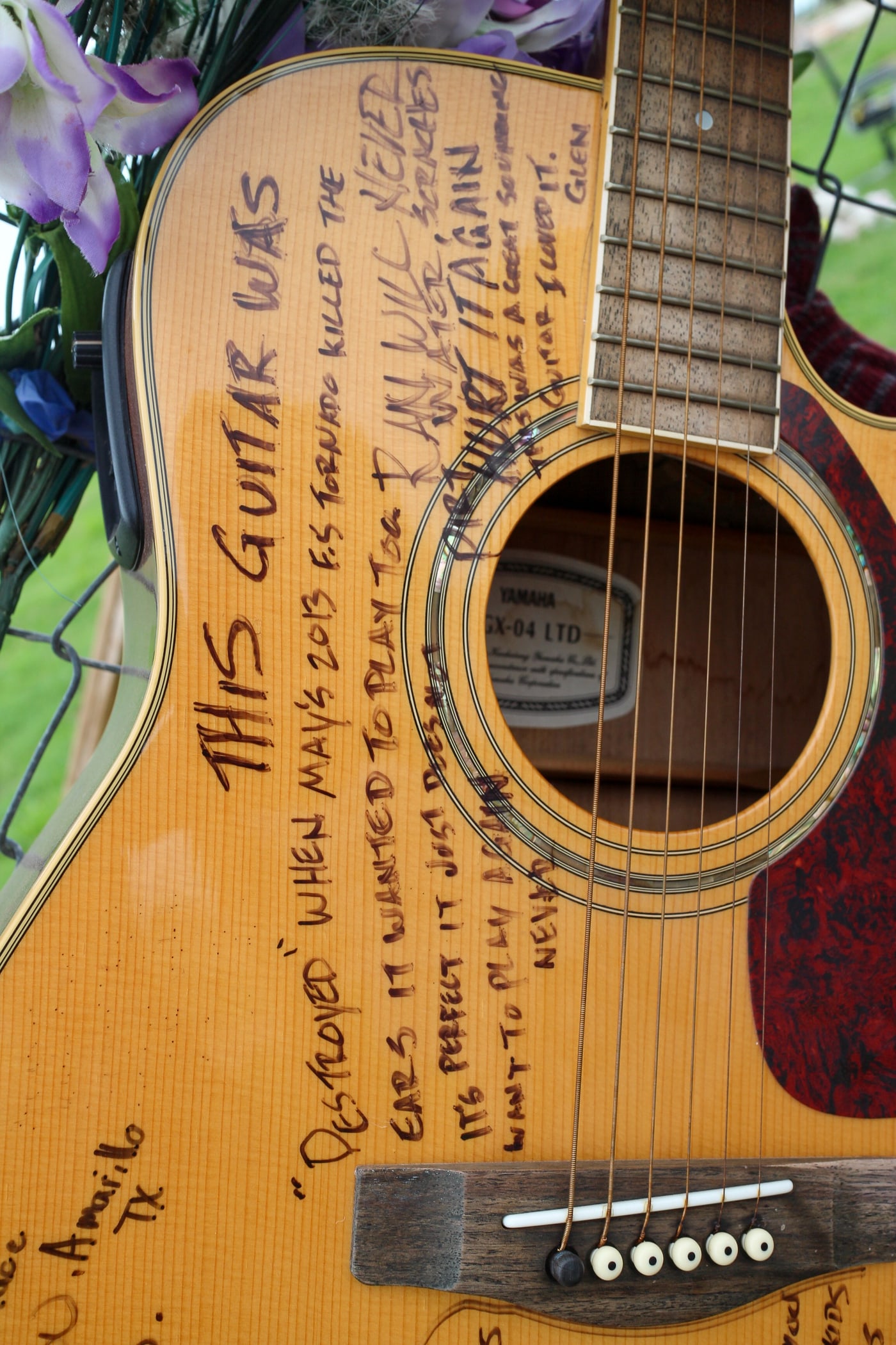 Signed guitar detail for music and motion storytelling.