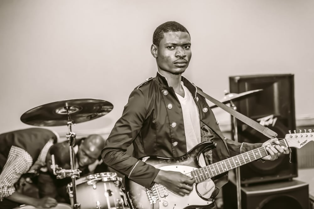Music portrait with guitar and studio-documentary feel.
