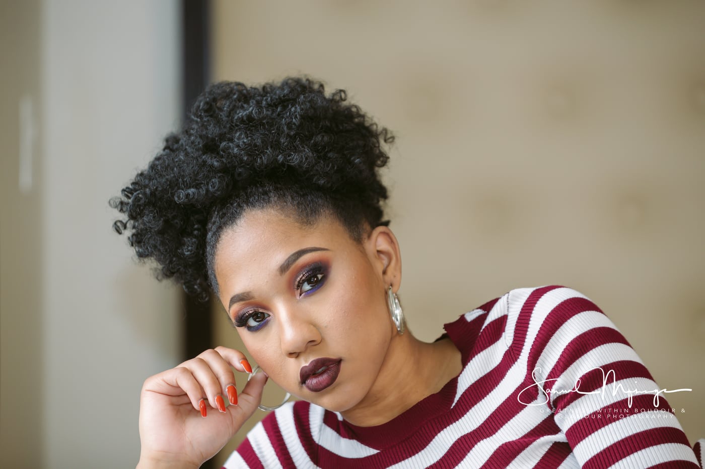 Beauty portrait, afro, striped top, glam, polished beauty.