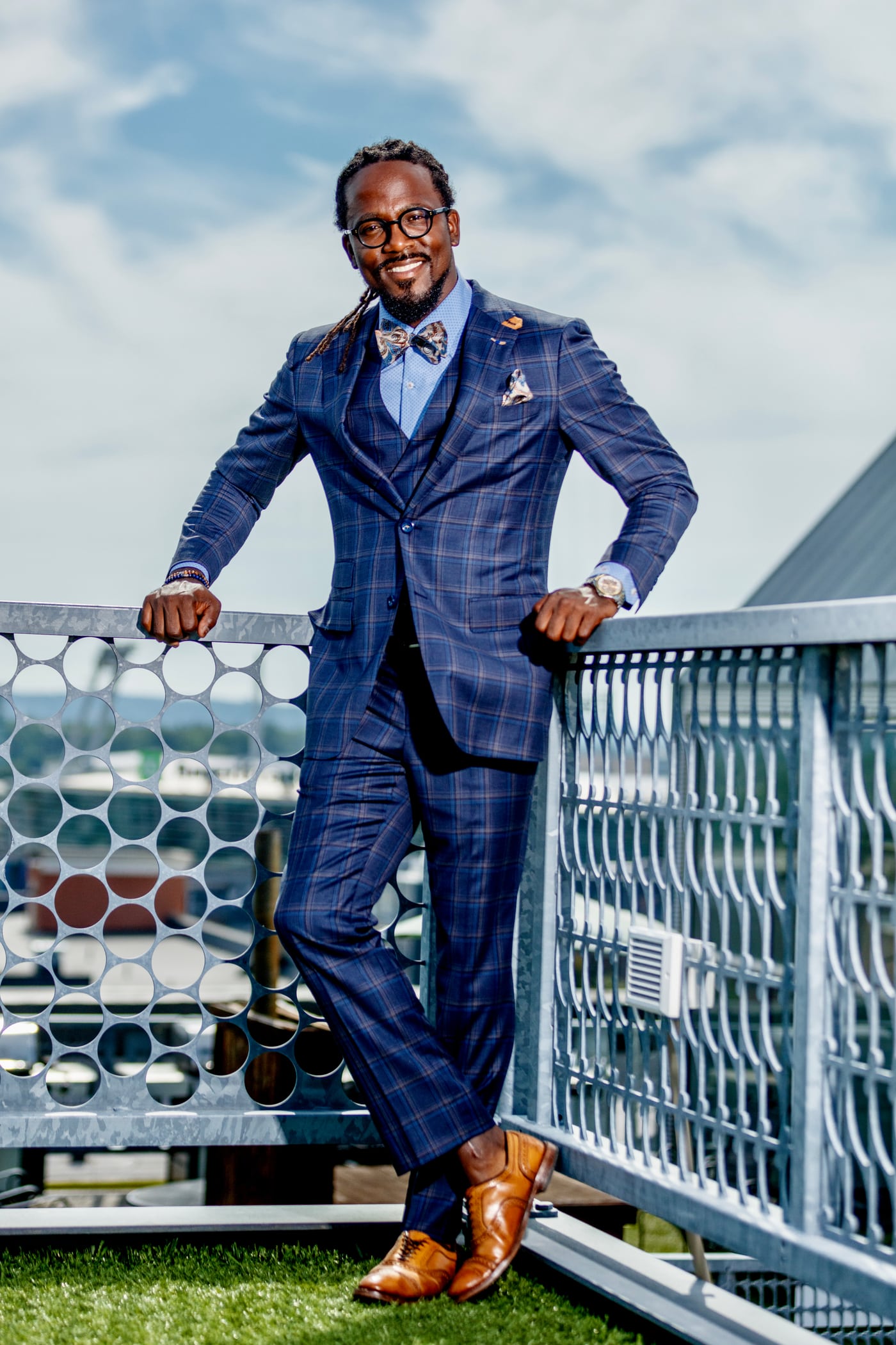 Executive blue suit above skyline, aspirational portrait.