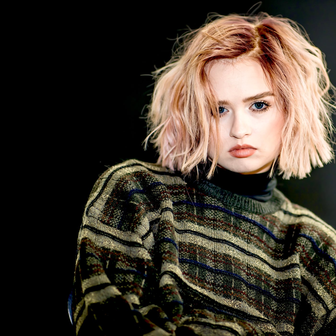 Woman blonde bob, olive turtleneck, fashion editorial.