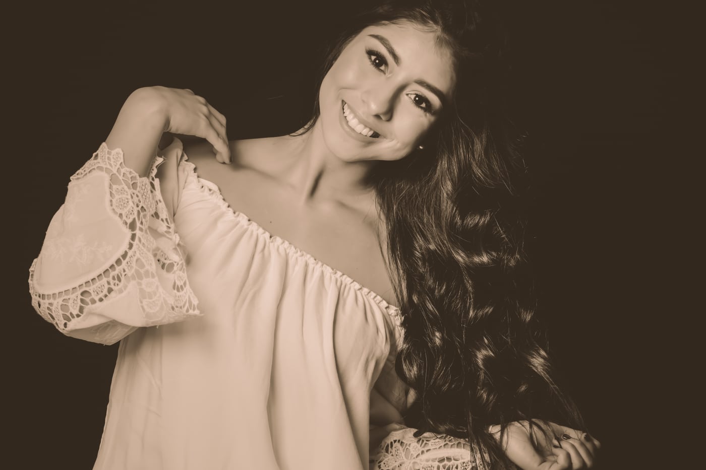 B&W off-shoulder, arm raised, editorial.
