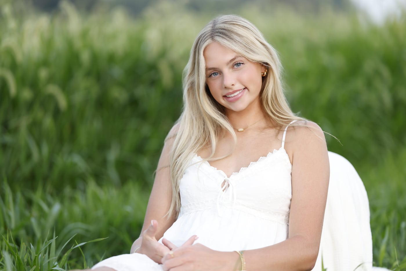 Blonde senior white dress, grass.