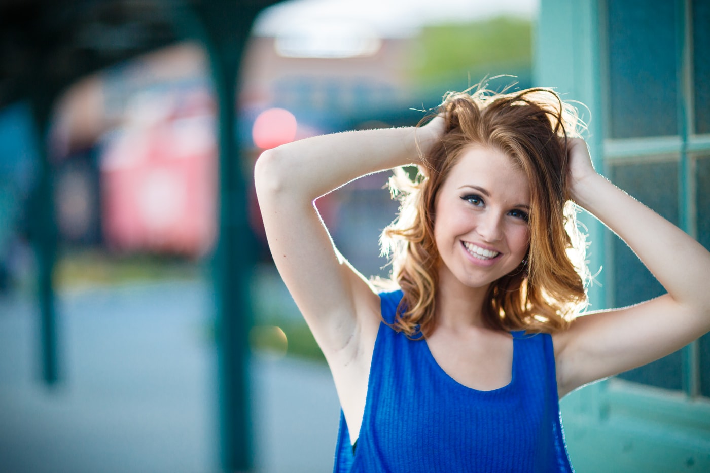 Senior portrait with clean blue backdrop.