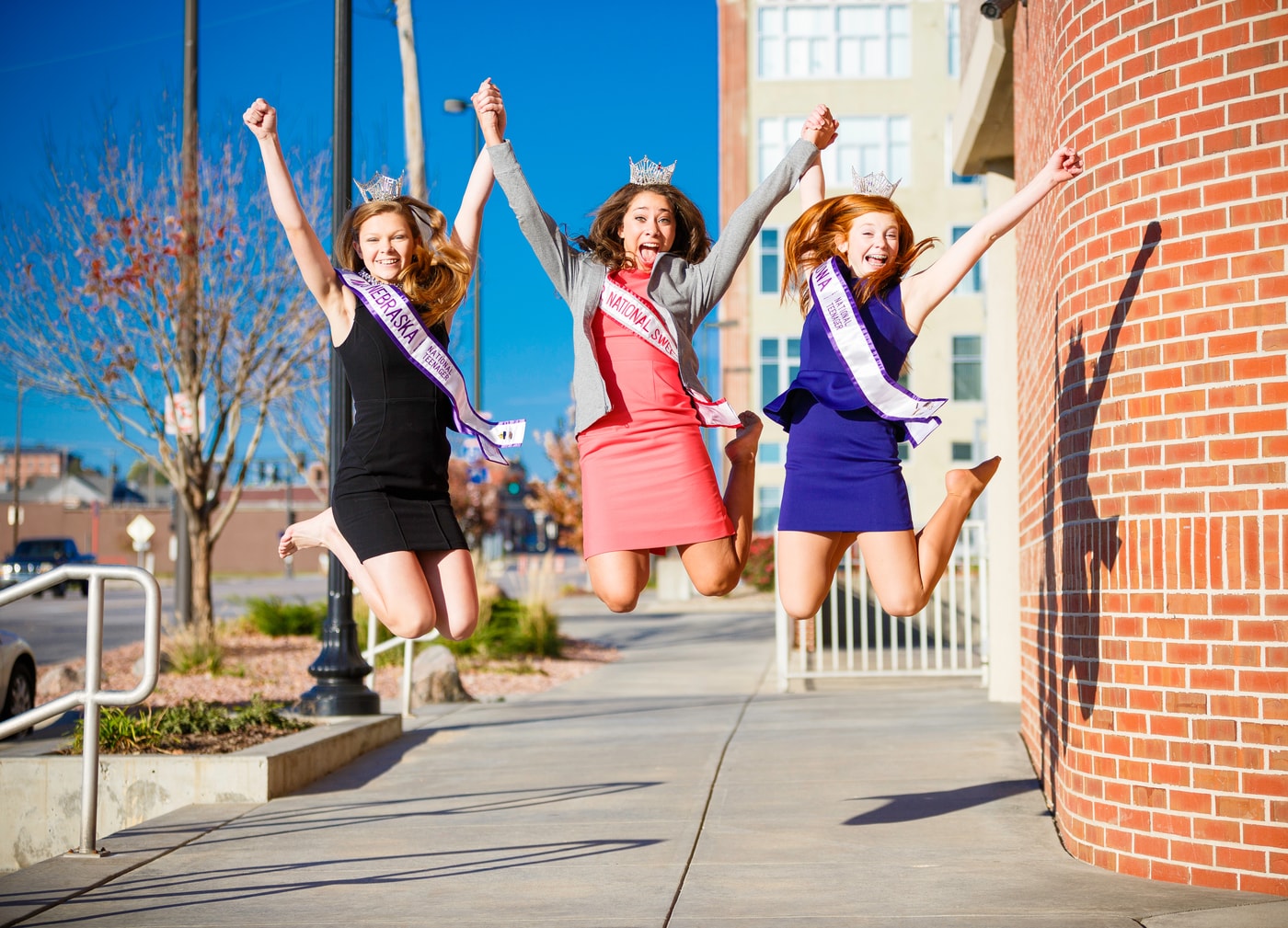 Graduation friends jumping portrait.
