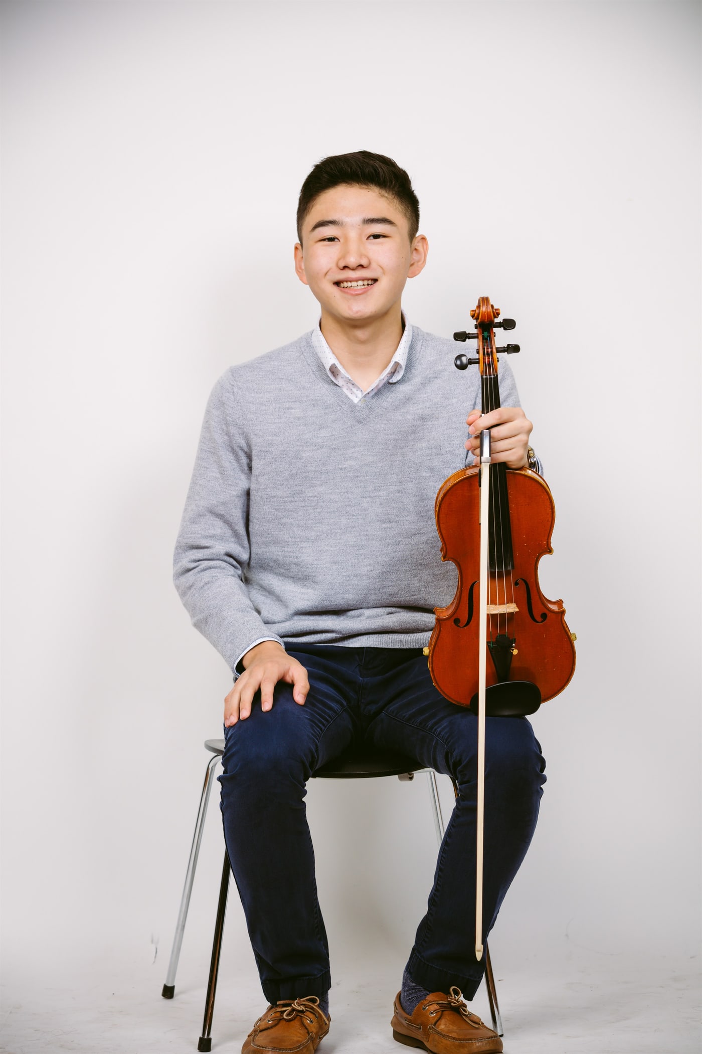 Studio senior musician portrait with violin.