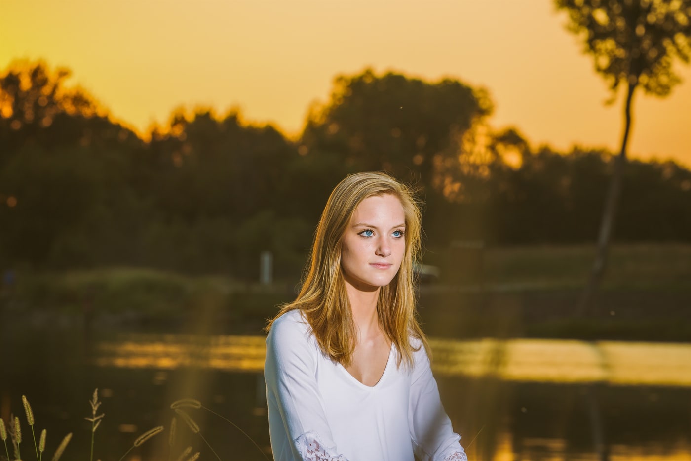 Golden-hour senior portrait by the water.