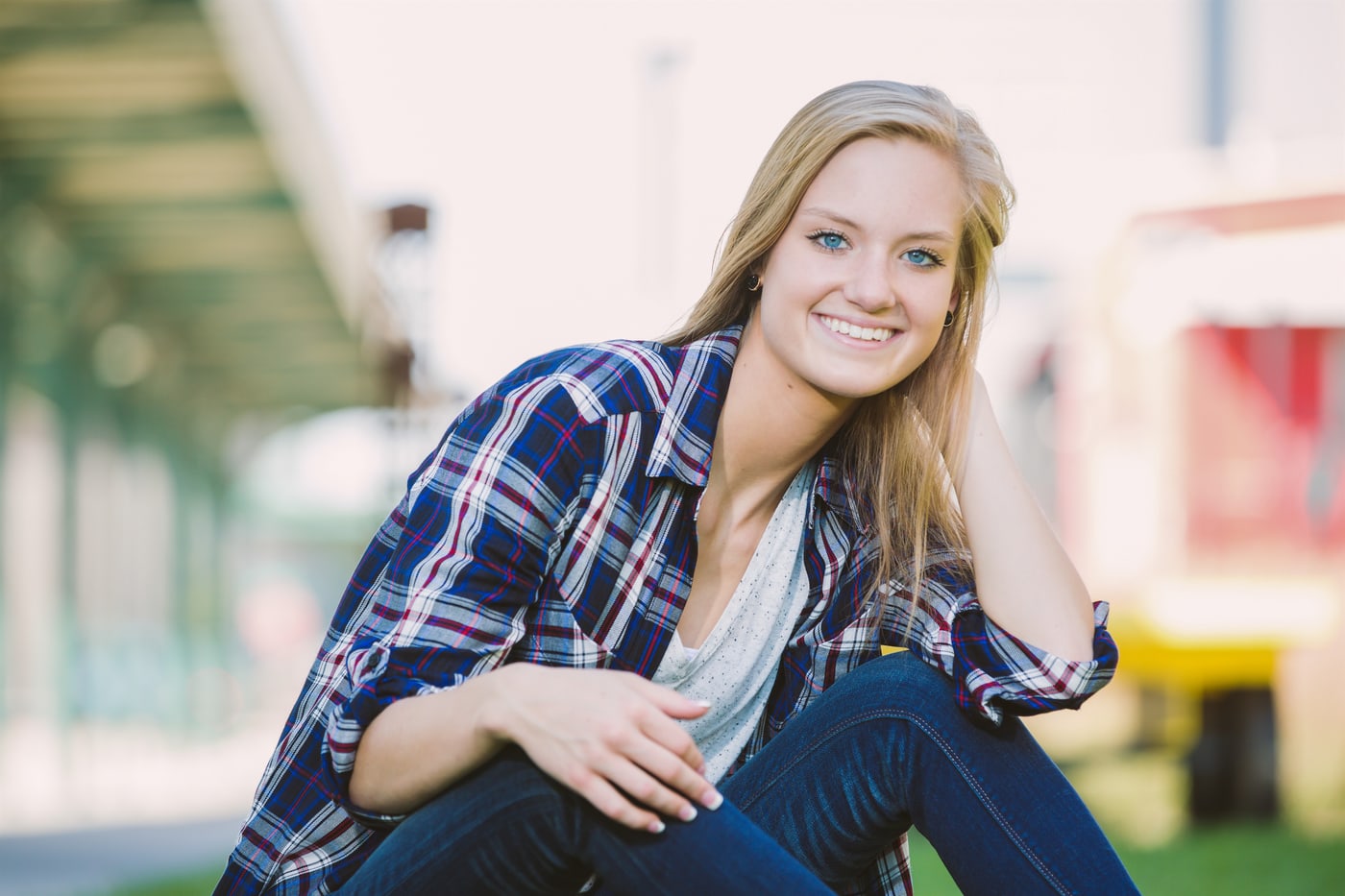 Senior portrait crouched in urban setting.