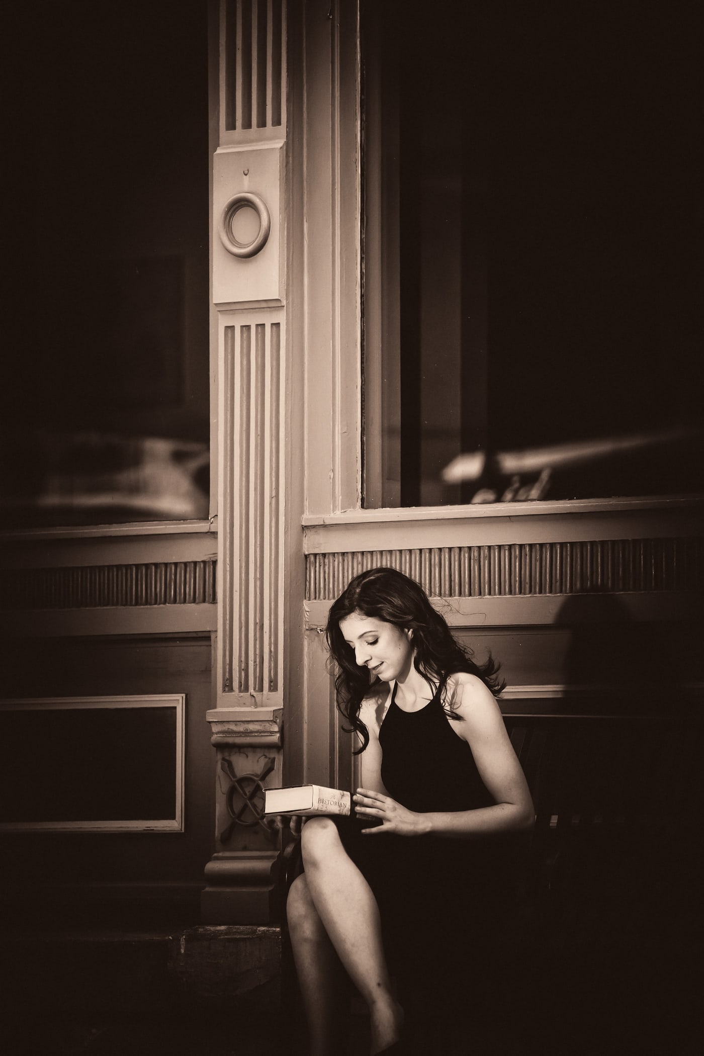 Dramatic black-and-white senior portrait with theatrical light.