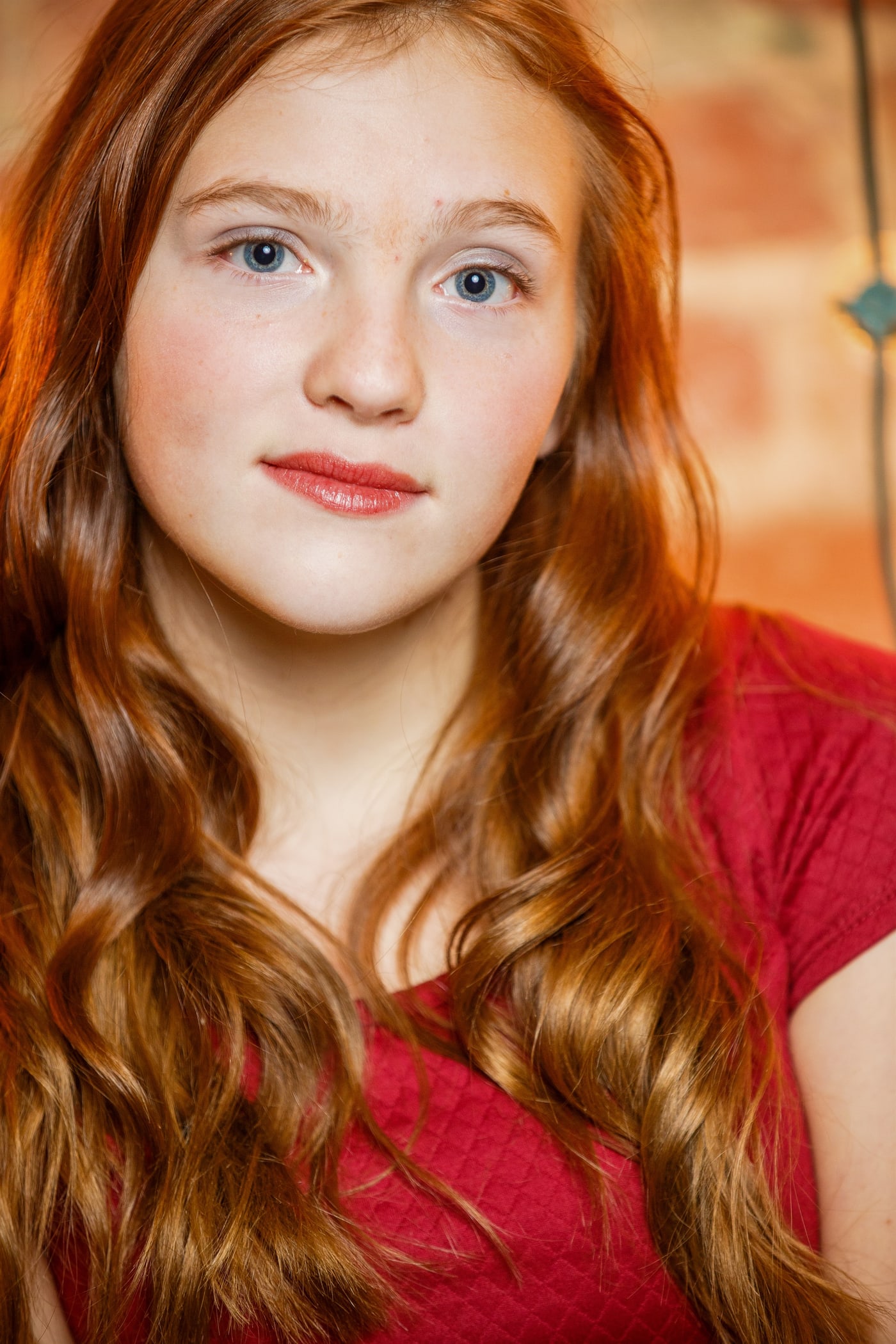 Close senior portrait with red hair and direct expression.
