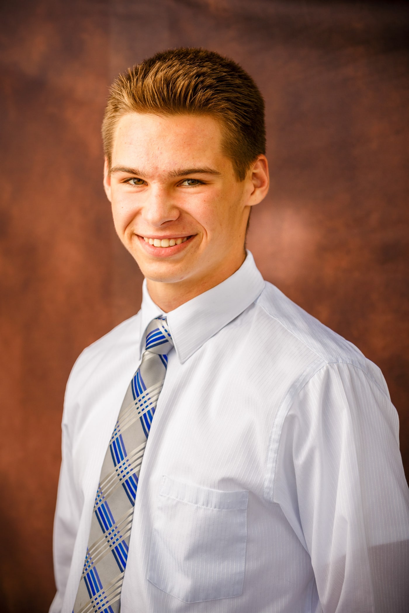 Formal senior portrait with shirt and tie.