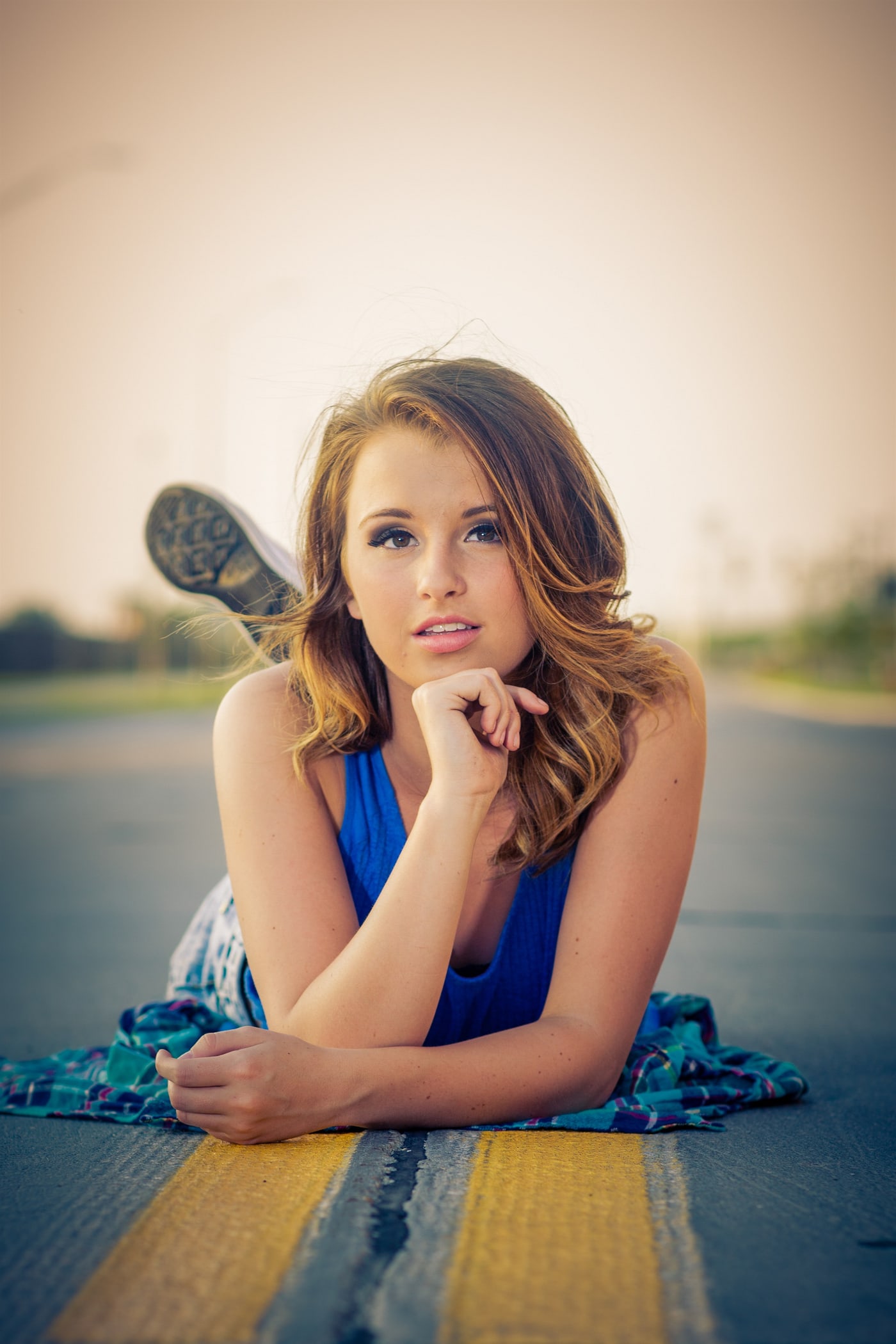 Senior portrait lying outdoors with shallow focus.