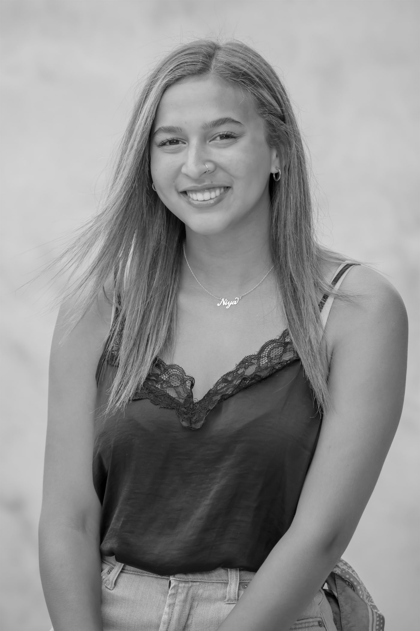 Black-and-white senior portrait seated.