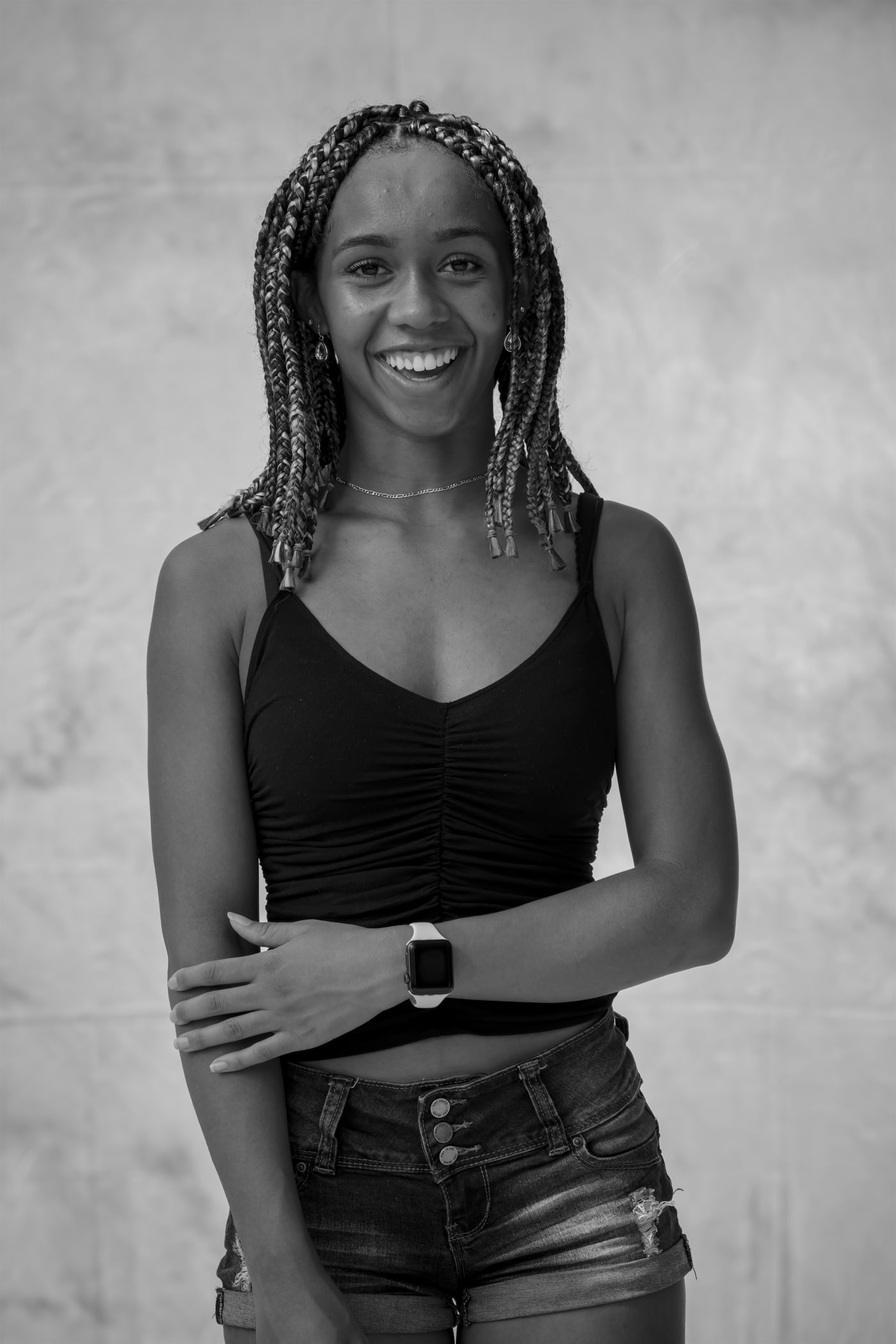 Black-and-white senior portrait standing.