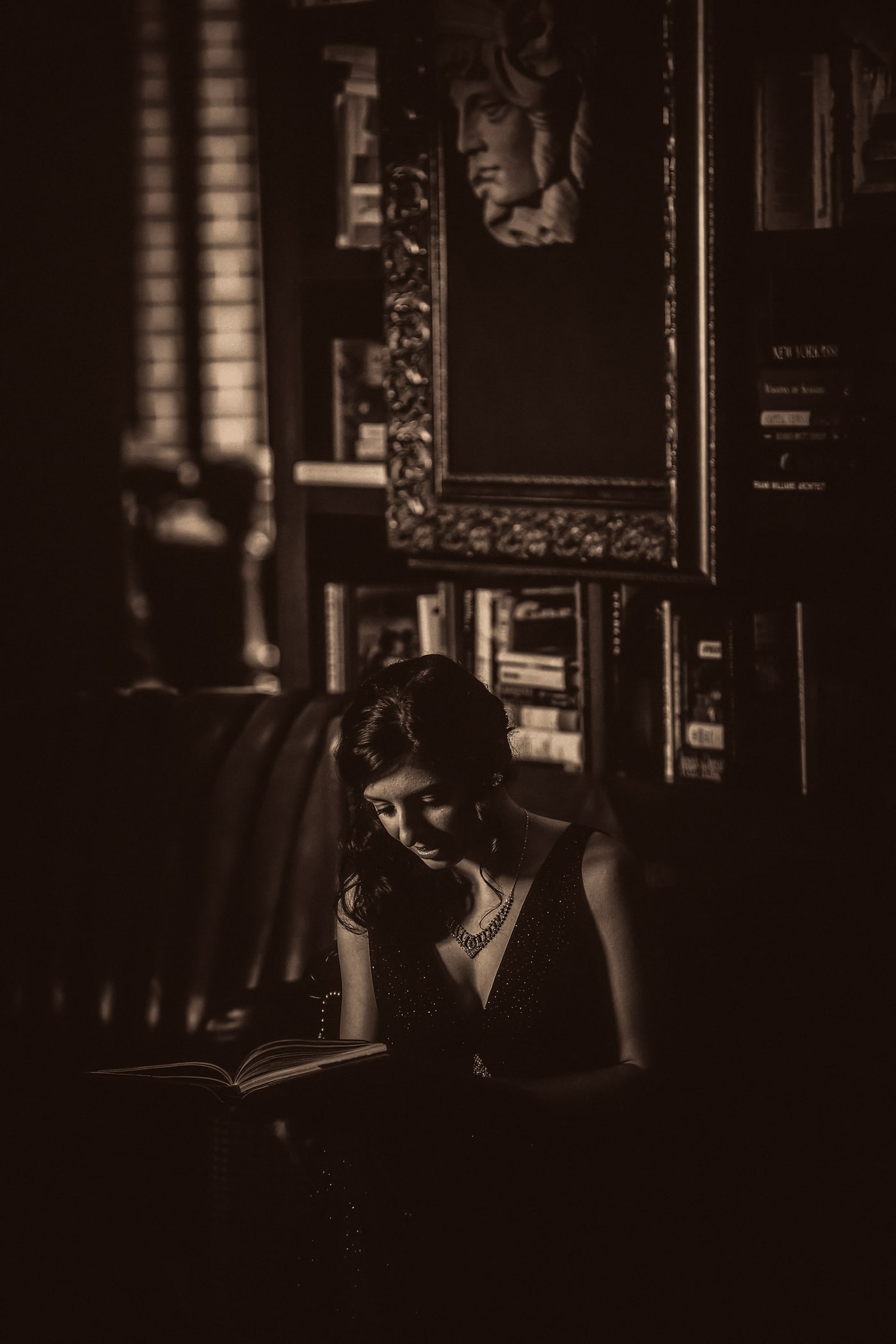 Dramatic black-and-white senior portrait in historic interior.