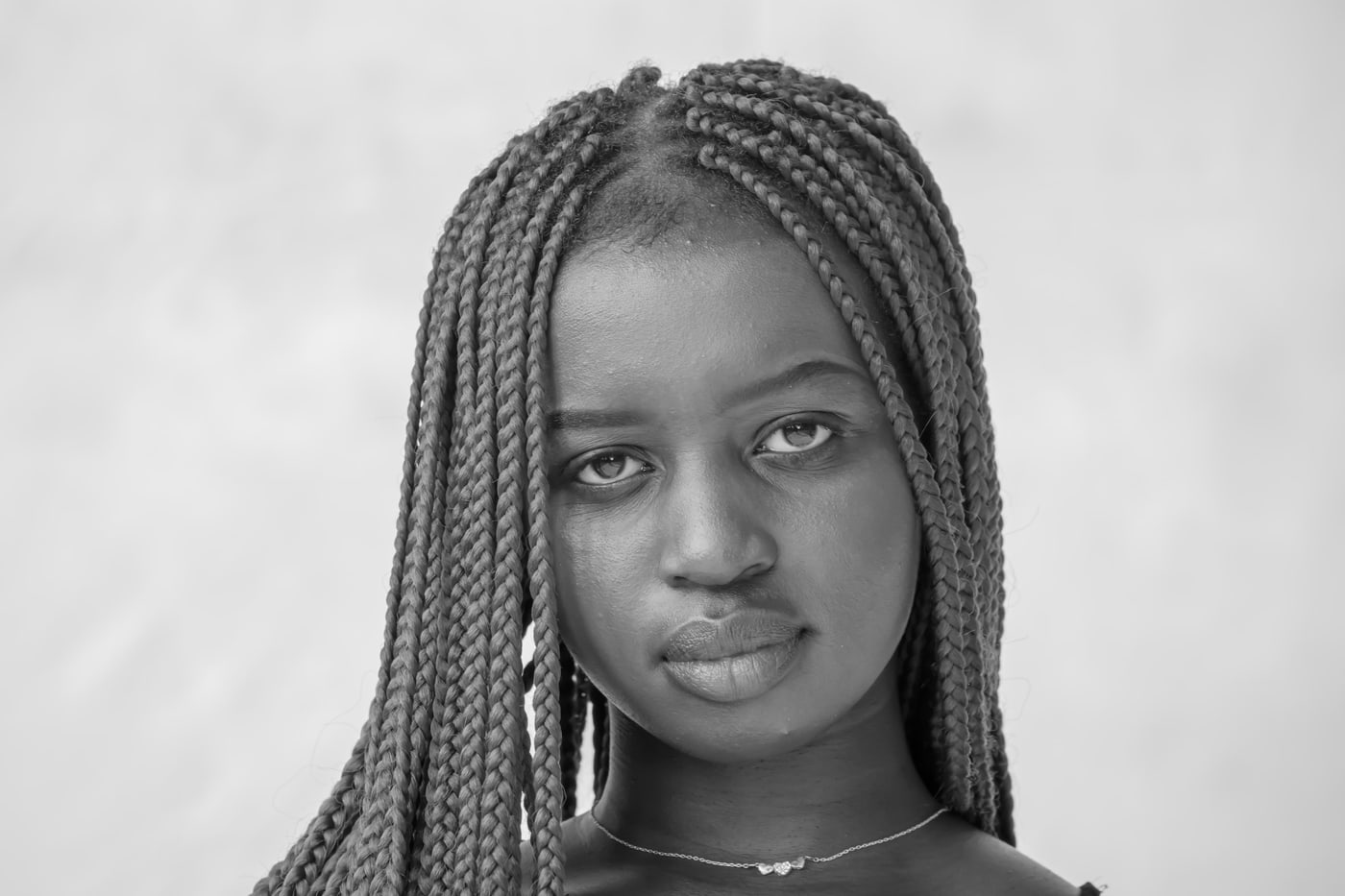 Black-and-white senior portrait with direct gaze.