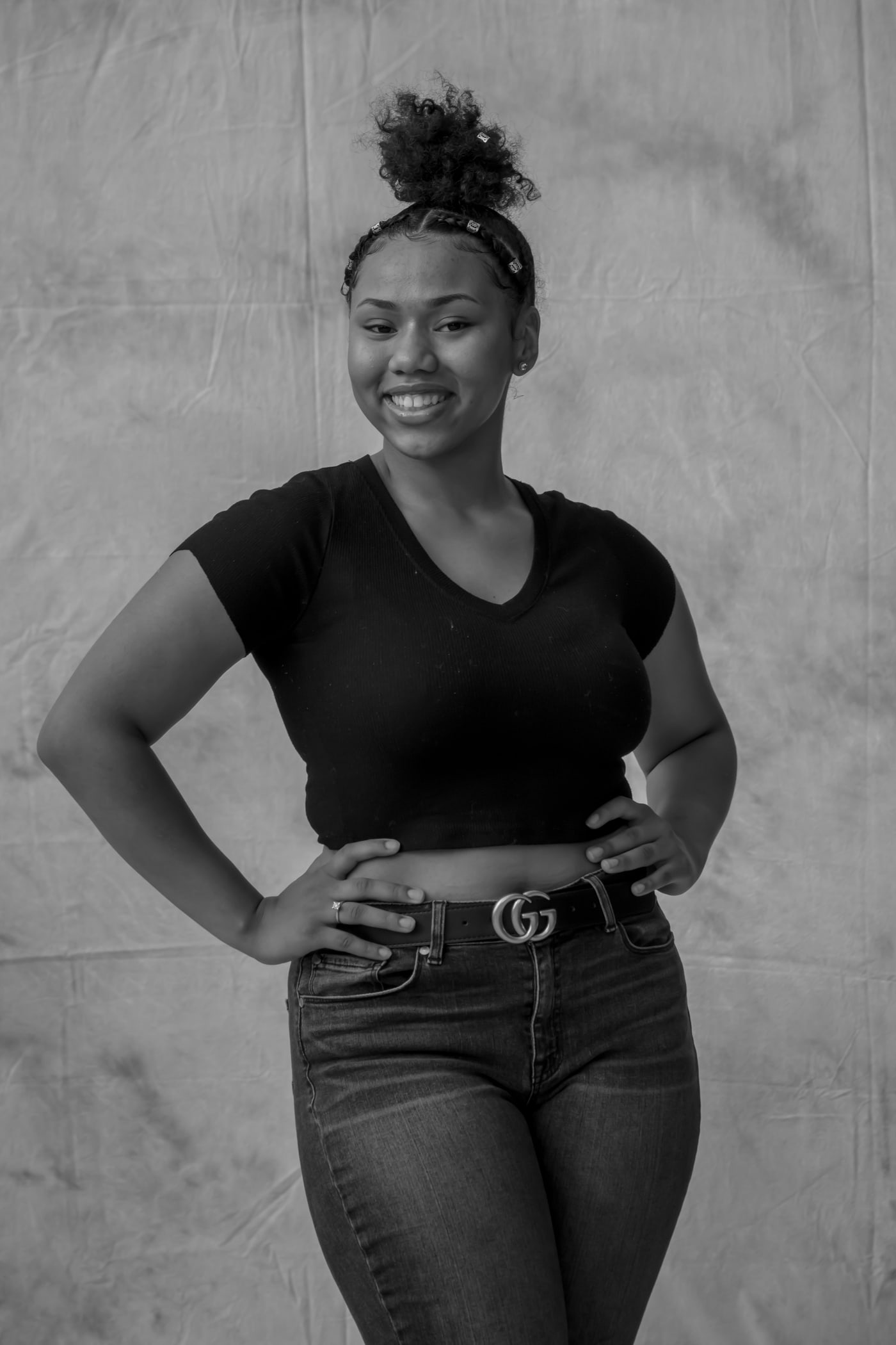 Black-and-white senior portrait standing, clean studio style.