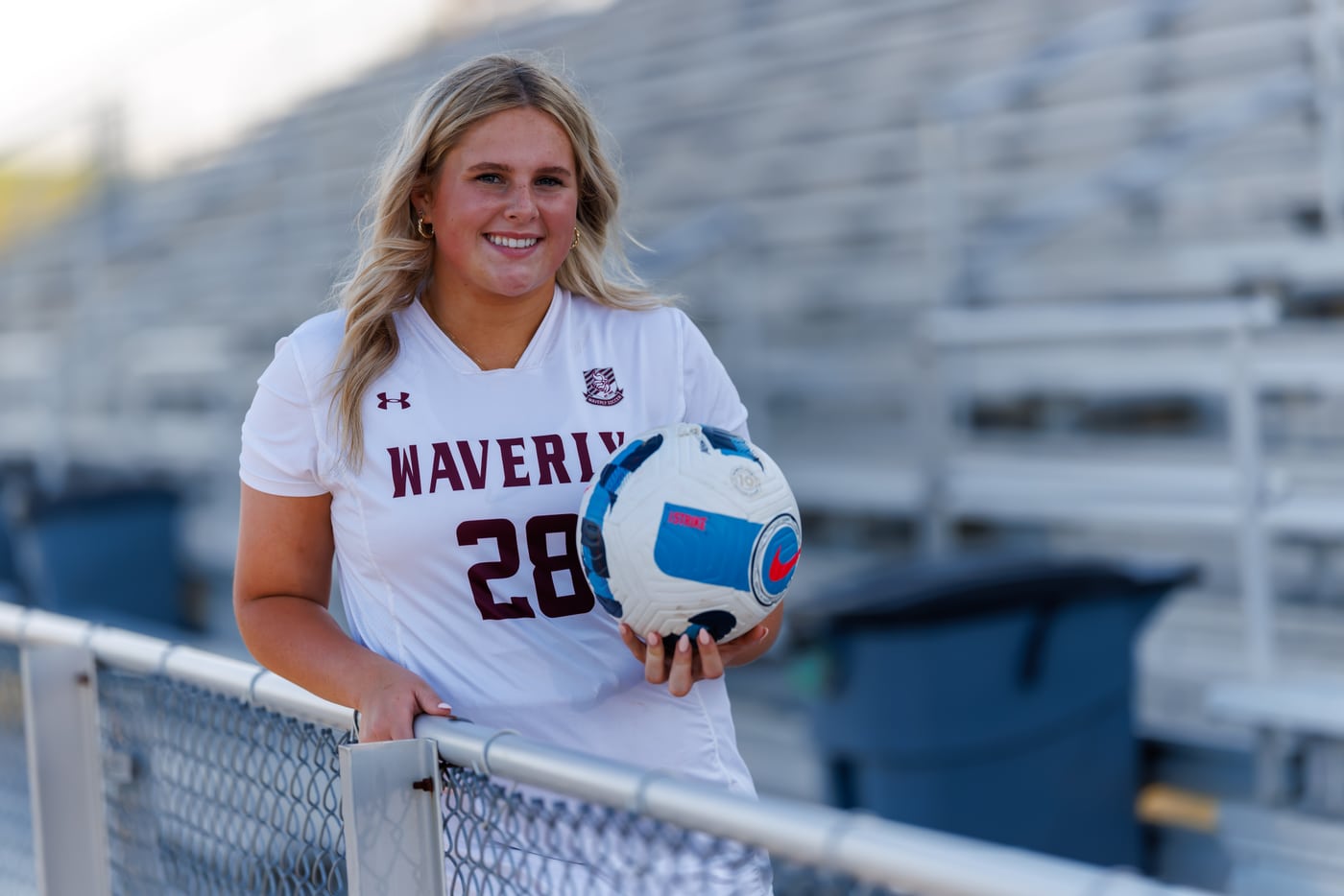 Waverly soccer senior #28 with ball, stadium.