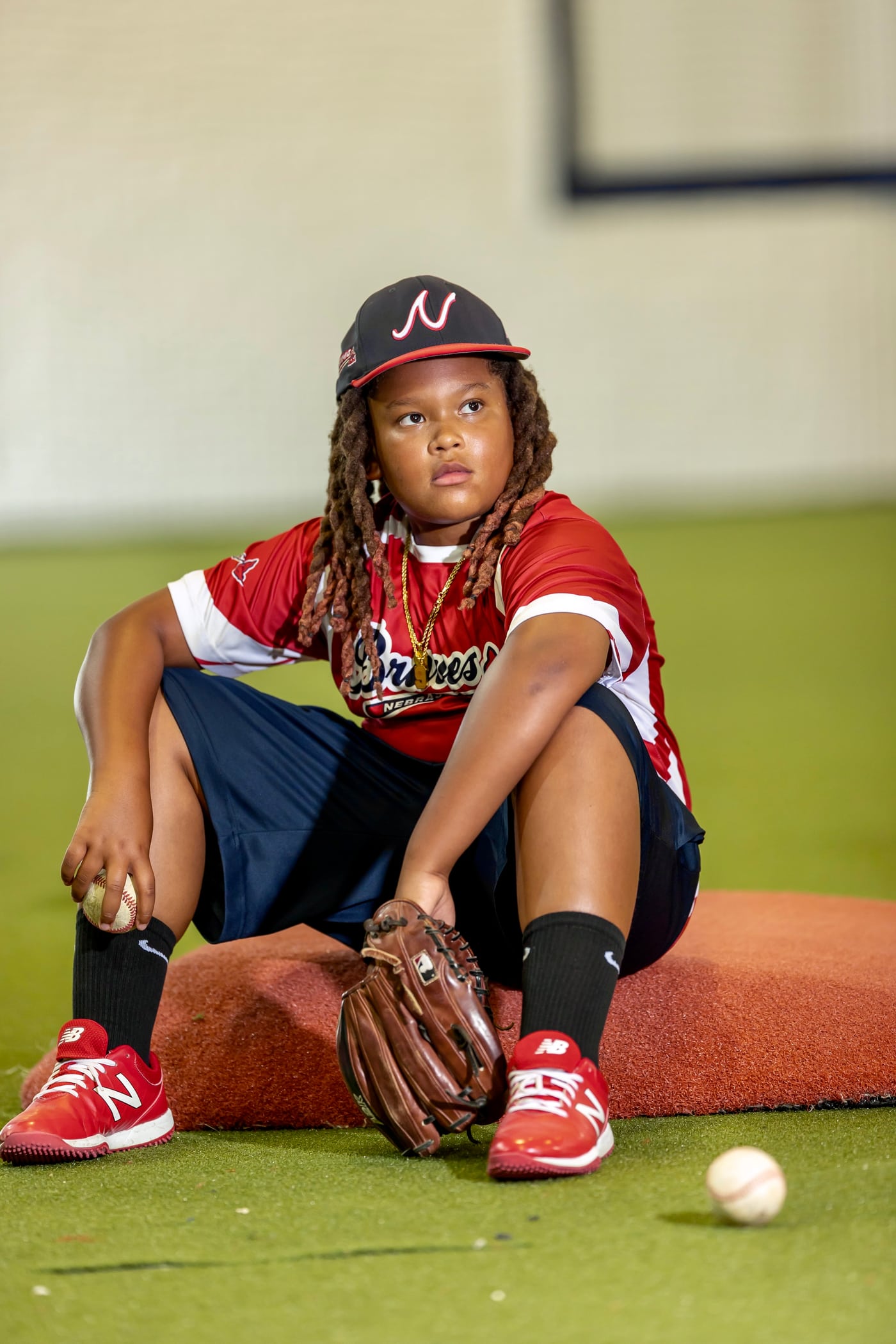 Gators #24, arms crossed, seated on field, athlete portrait.