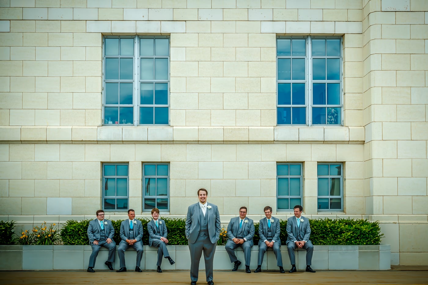 Wedding party on ledge, building, group.