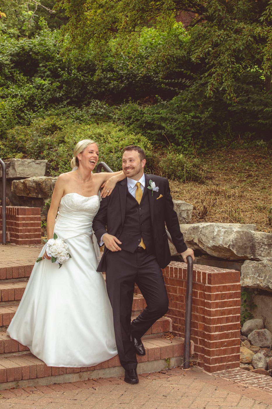 Bride and groom portrait in greenery.