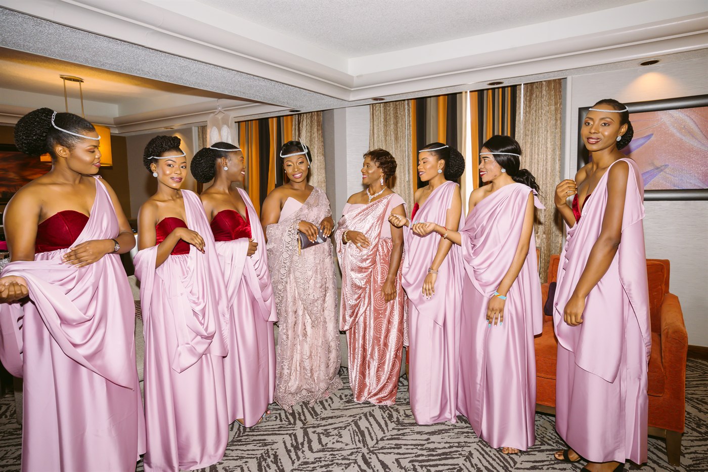 Bridesmaids in soft pink getting ready.