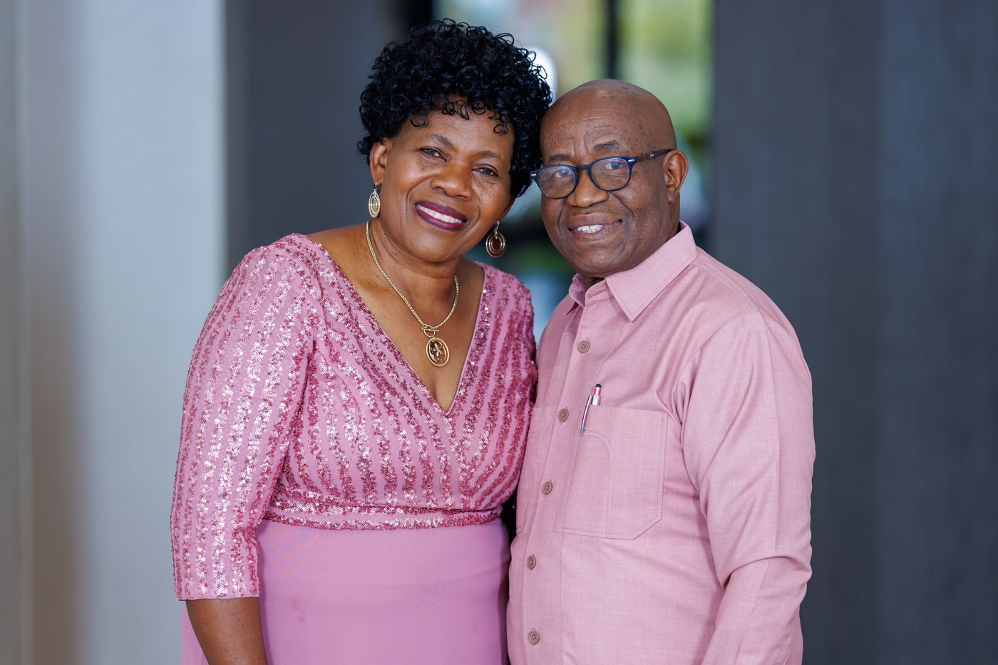 Formal couple portrait in pink styling.